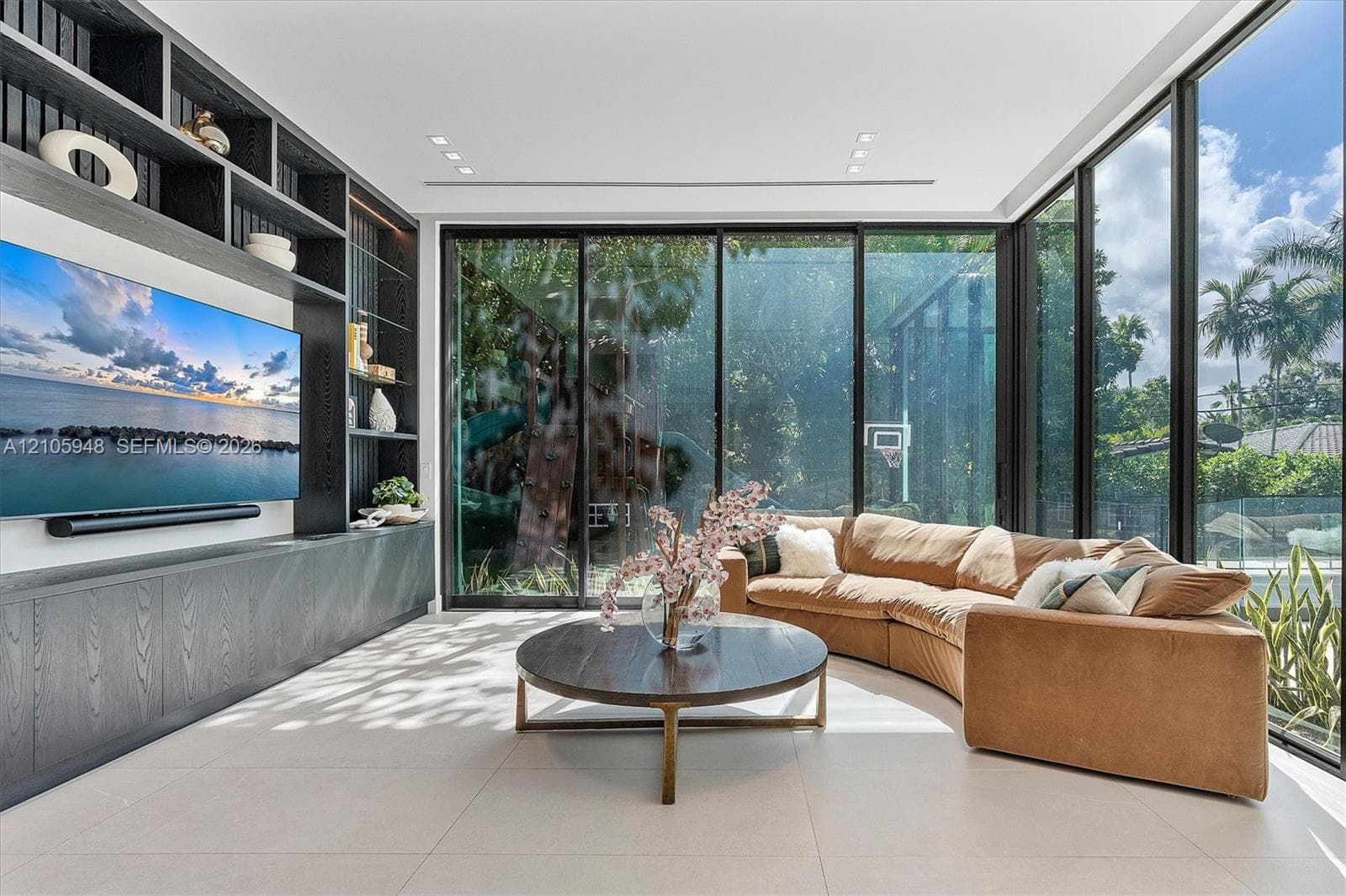Floor-to-ceiling glass wall, built-in floor-to-ceiling storage cabinetry with open shelving, neutral large-format tile flooring, and recessed ceiling lighting