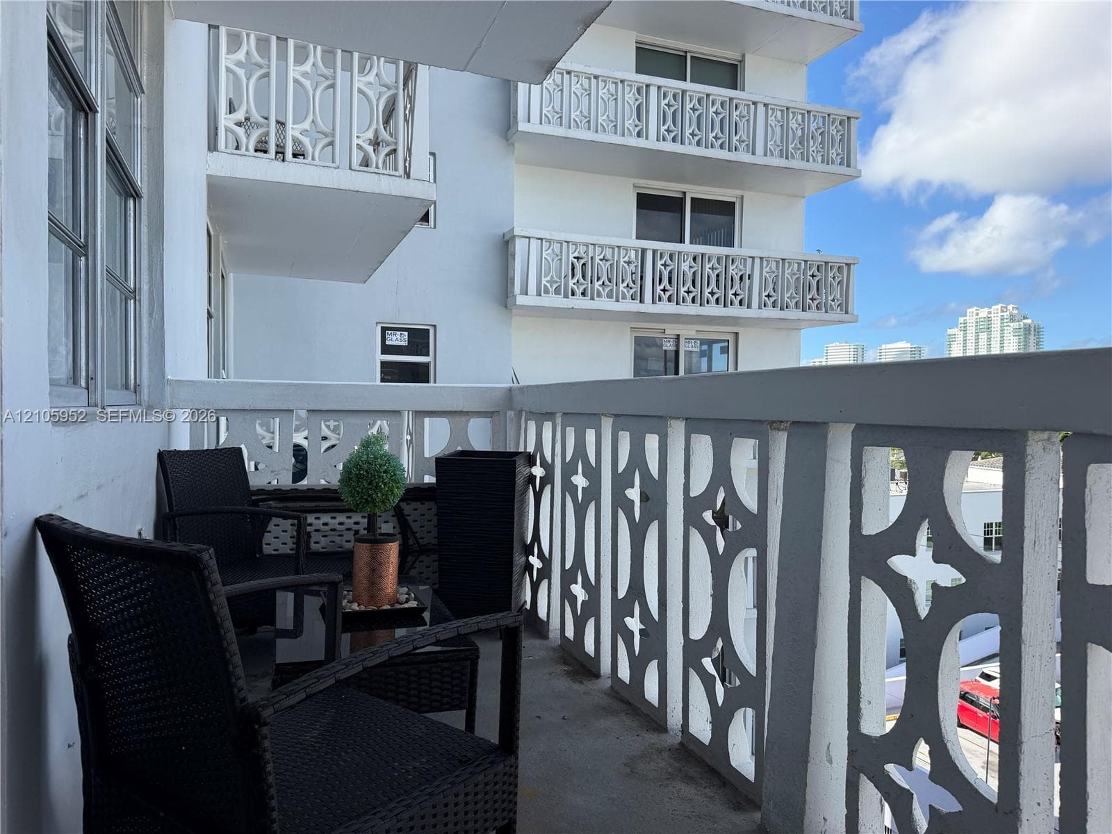 Private balcony featuring concrete flooring and decorative geometric balustrades