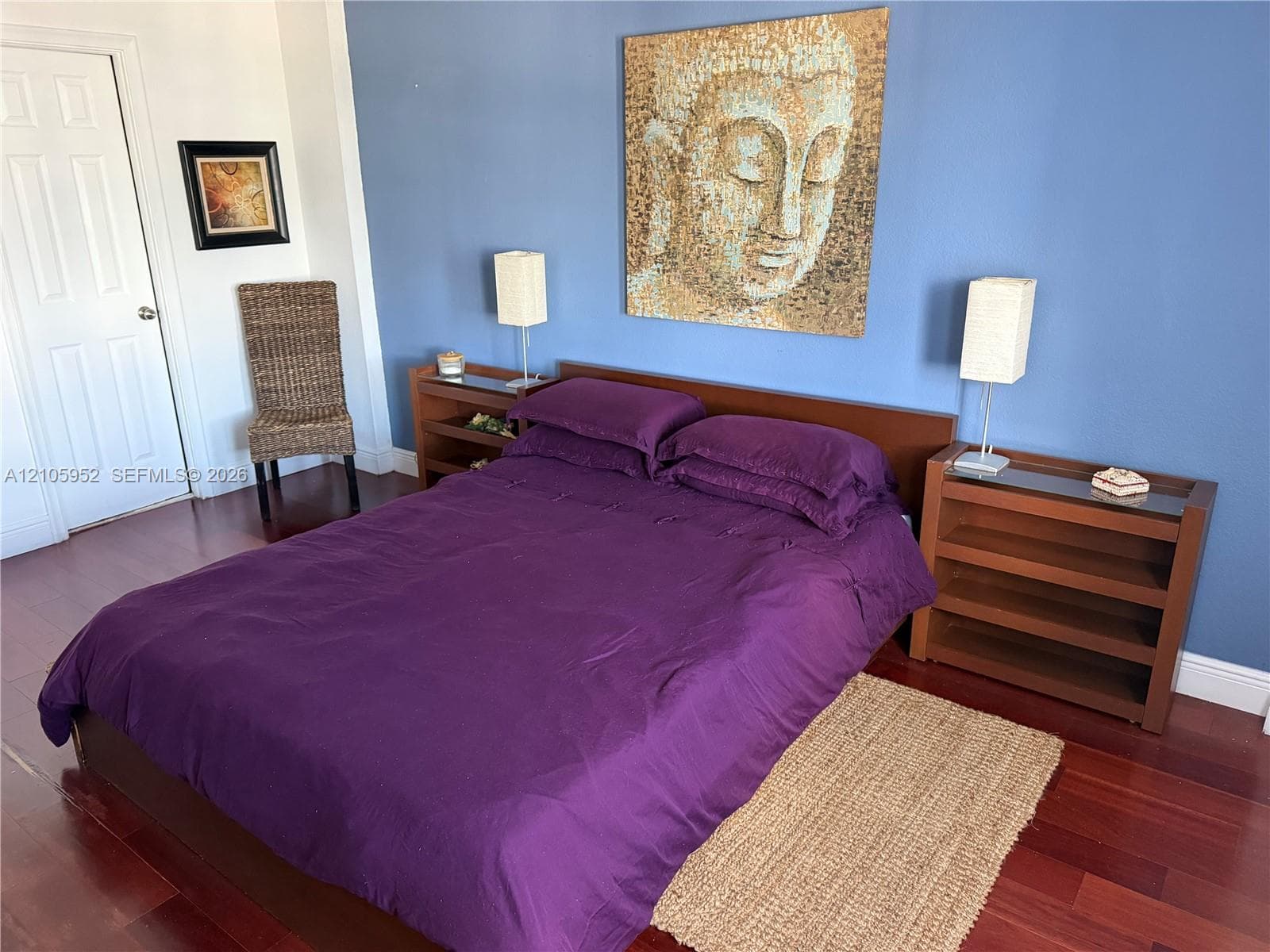 Wood-finish flooring, six-panel interior door, and smooth-finish walls