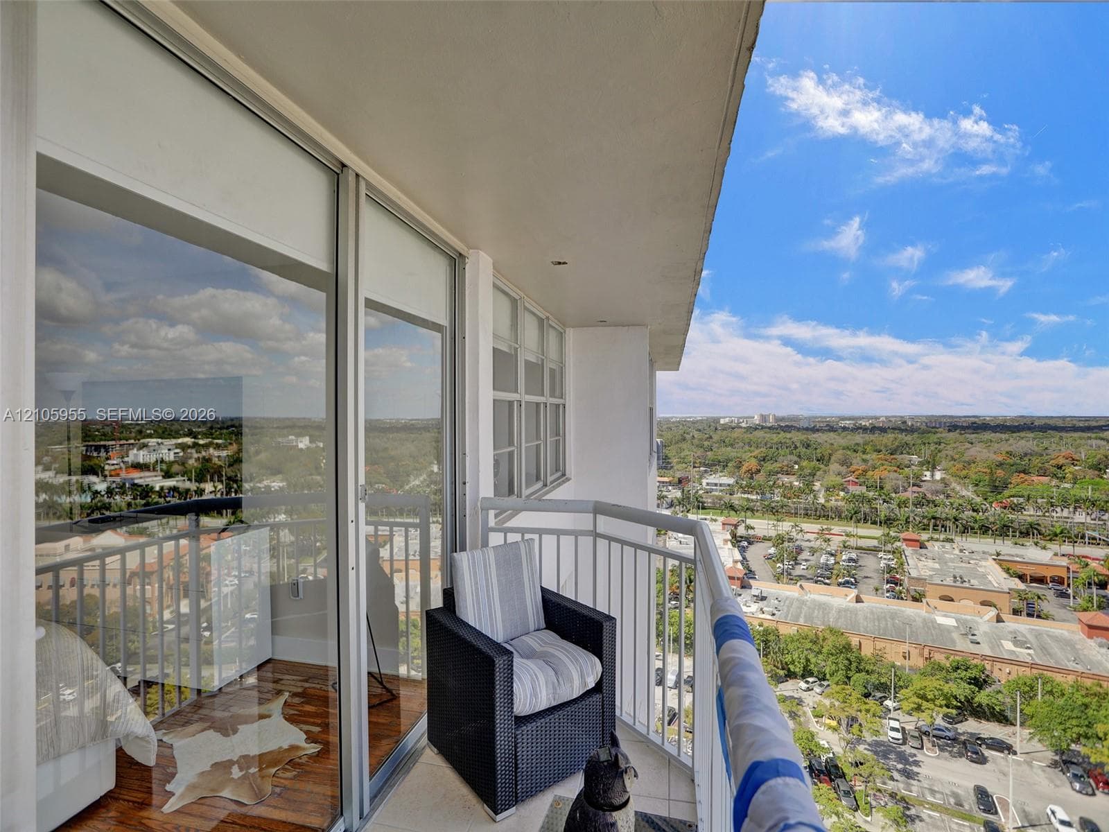 Private balcony featuring floor-to-ceiling sliding glass doors and metal railing