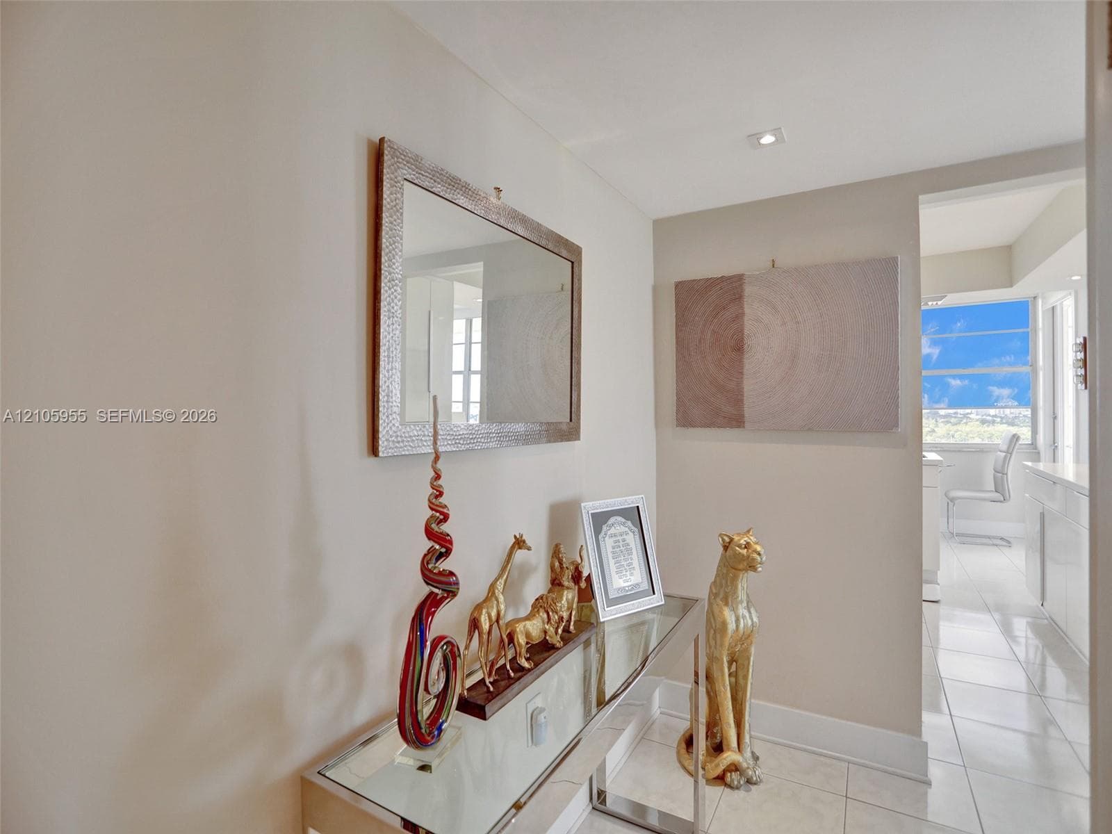 Neutral wall tones, high-gloss tile flooring, and recessed ceiling lighting