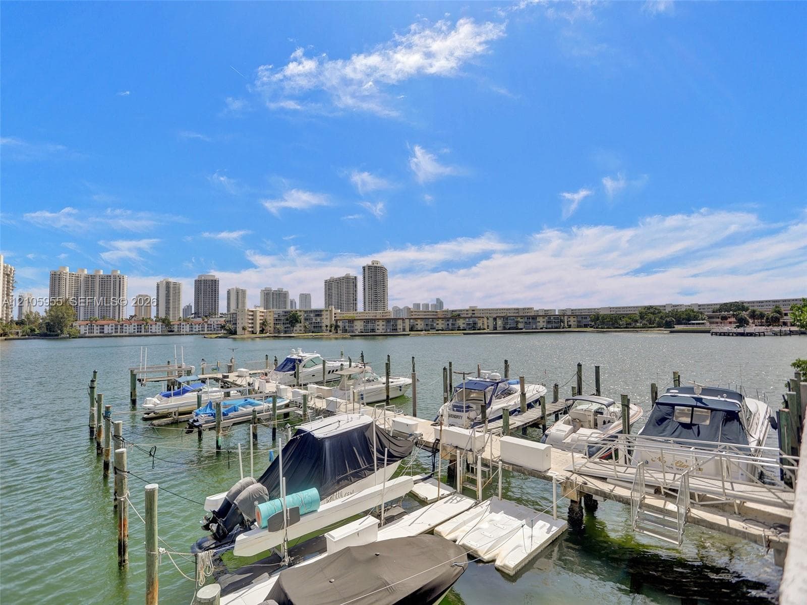 Waterfront dock featuring multiple boat slips and pilings