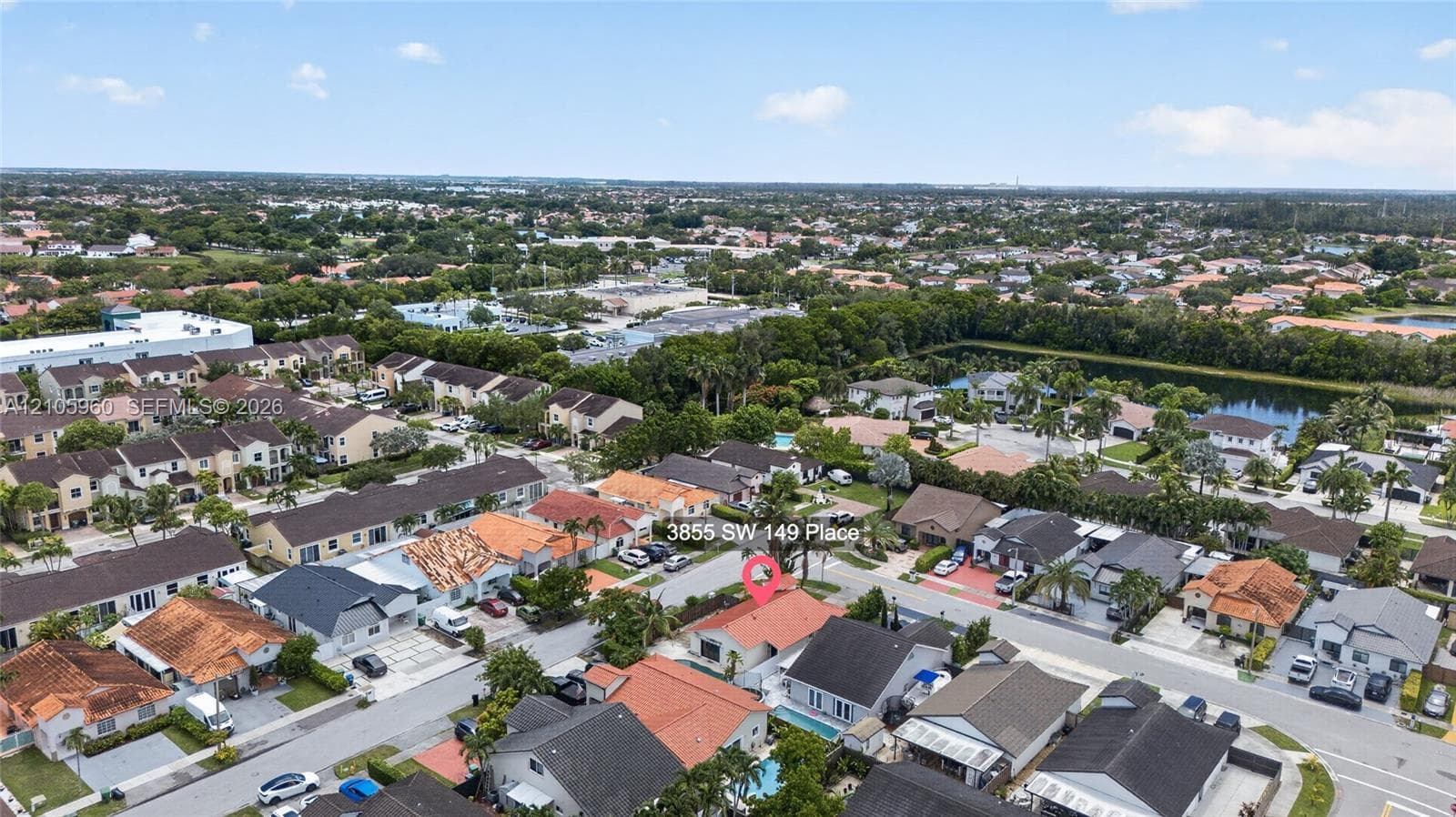 Aerial perspective of property featuring a tile roof, private swimming pool, and concrete driveway