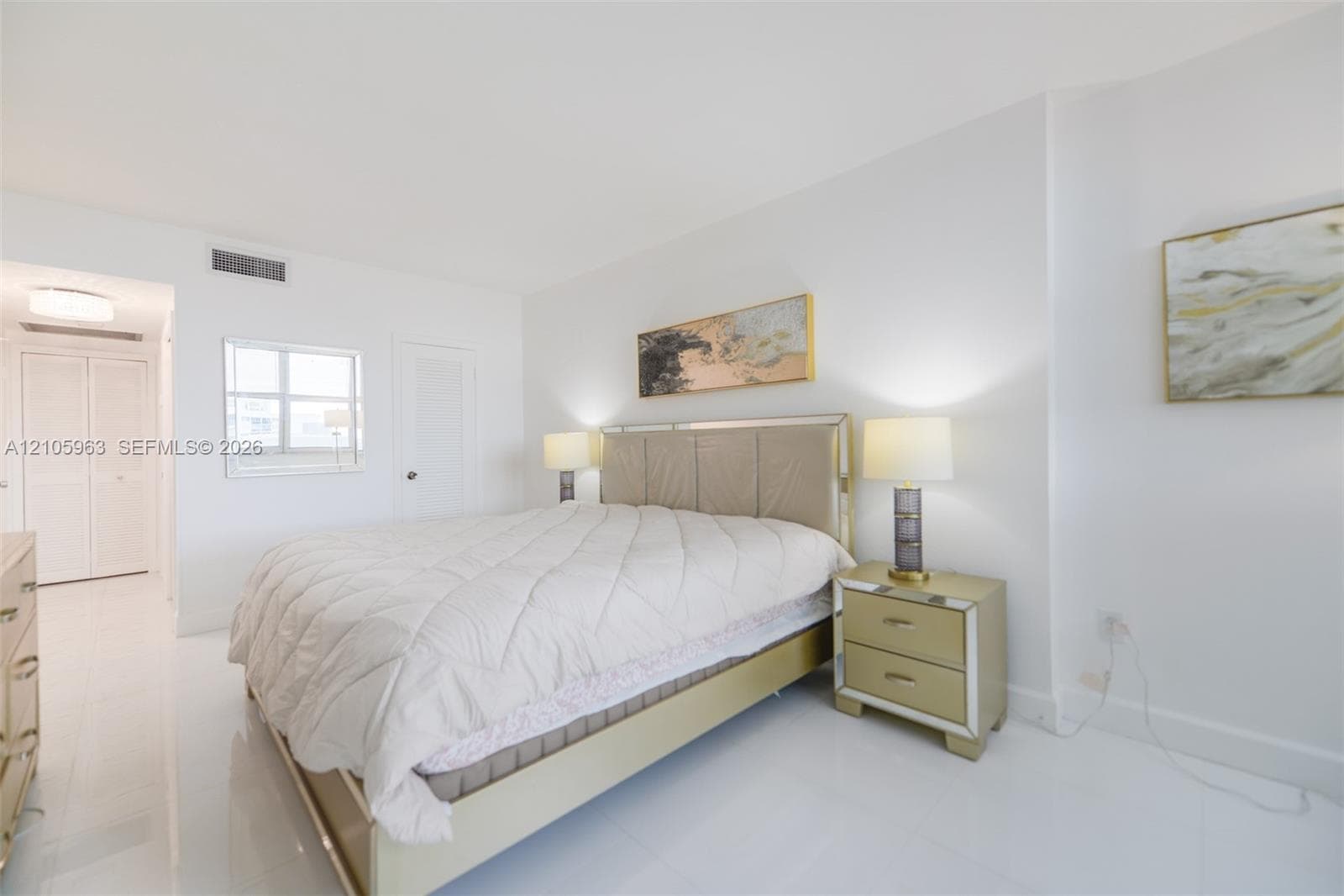 Bright interior space featuring polished tile flooring, smooth ceilings, and a large window