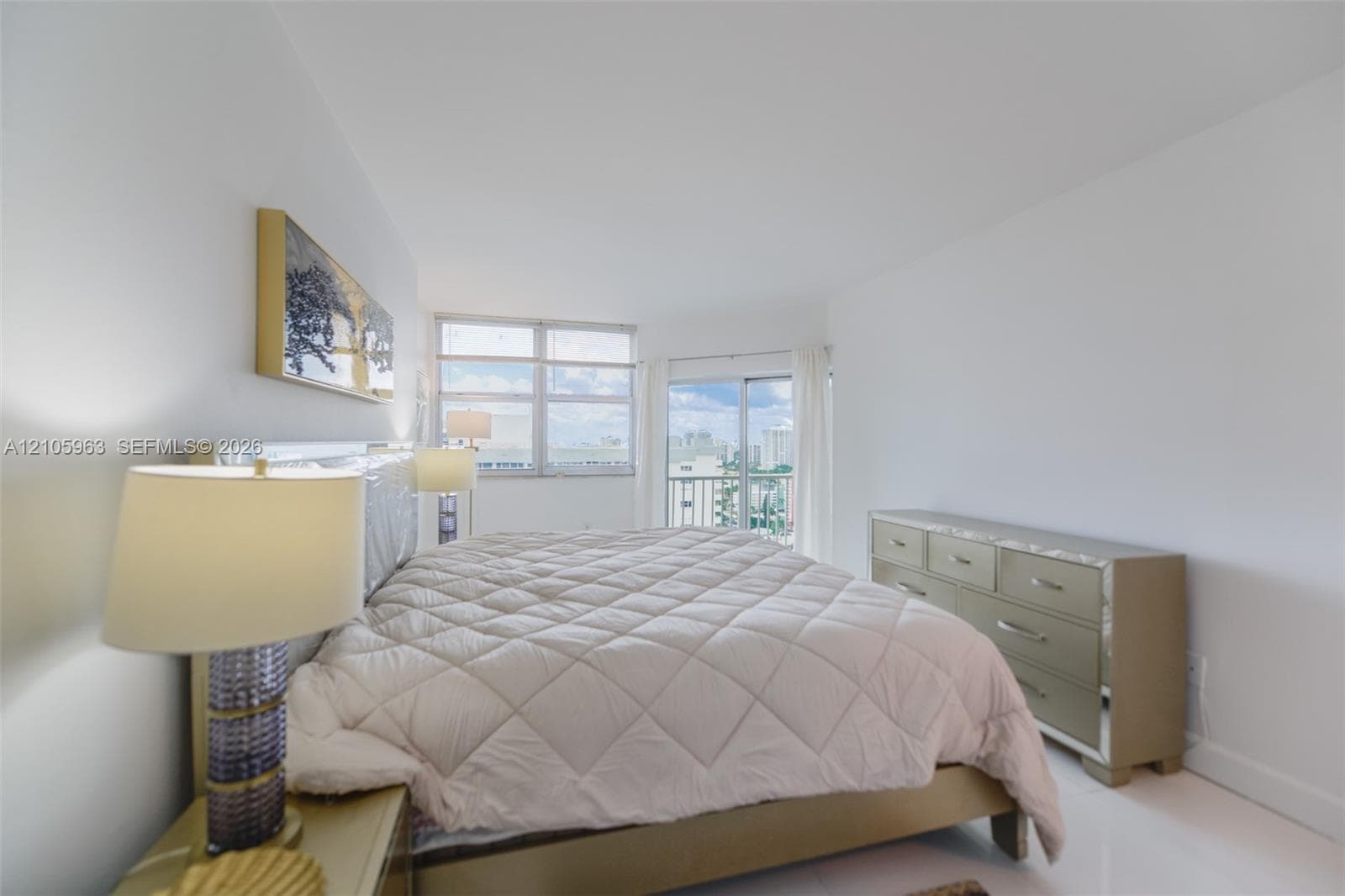 Neutral interior featuring high-gloss flooring, floor-to-ceiling windows, and sliding glass doors with access to an exterior balcony