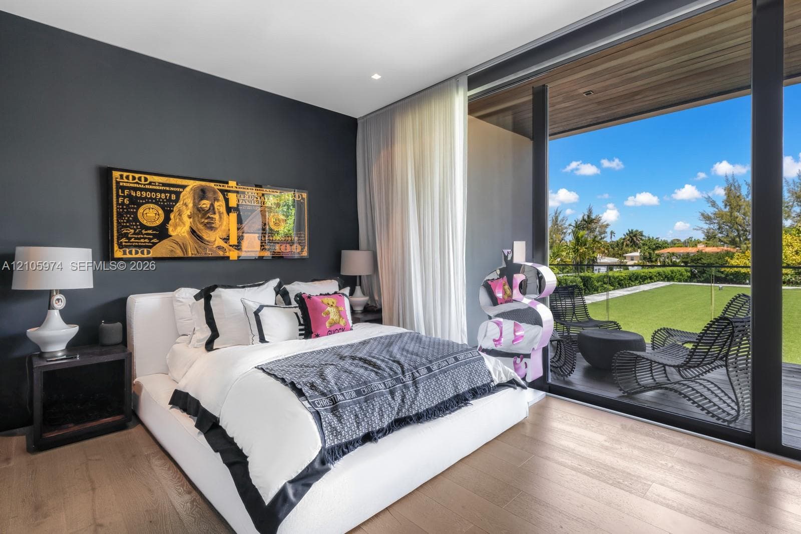 Floor-to-ceiling glass sliding doors, wood-finish flooring, dark-toned accent wall, and a recessed ceiling with wood-plank paneling