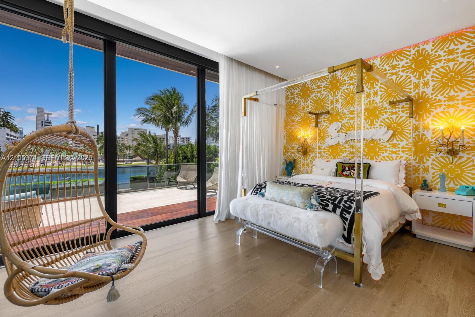 Floor-to-ceiling sliding glass walls, expansive terrace with wood-finish decking, glass-panel railing, and wood-finish flooring