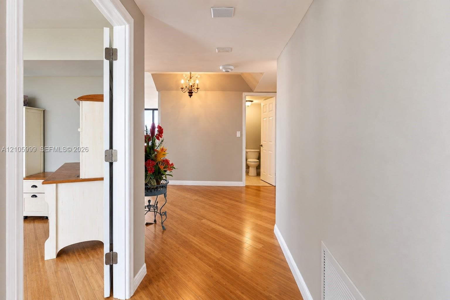 Interior space featuring wood-finish flooring, recessed ceiling lighting, and a multi-arm chandelier