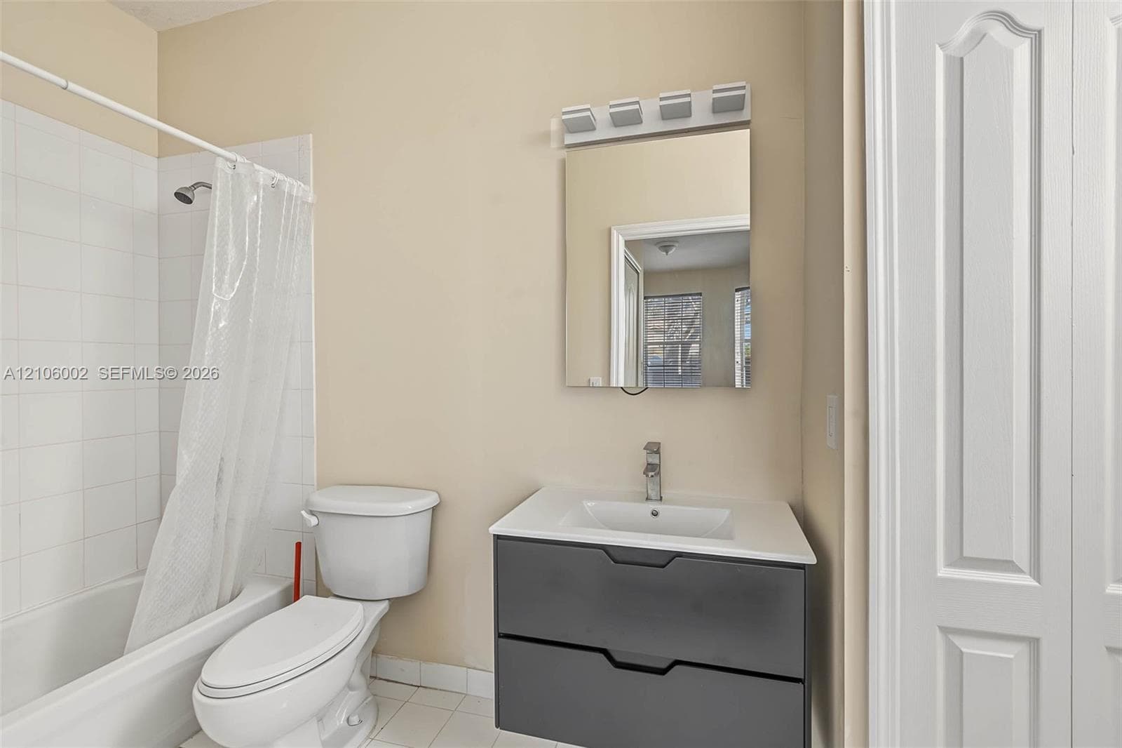 Modern vanity featuring a charcoal-finished dual-drawer cabinet, white countertop with integrated sink, and polished chrome faucet