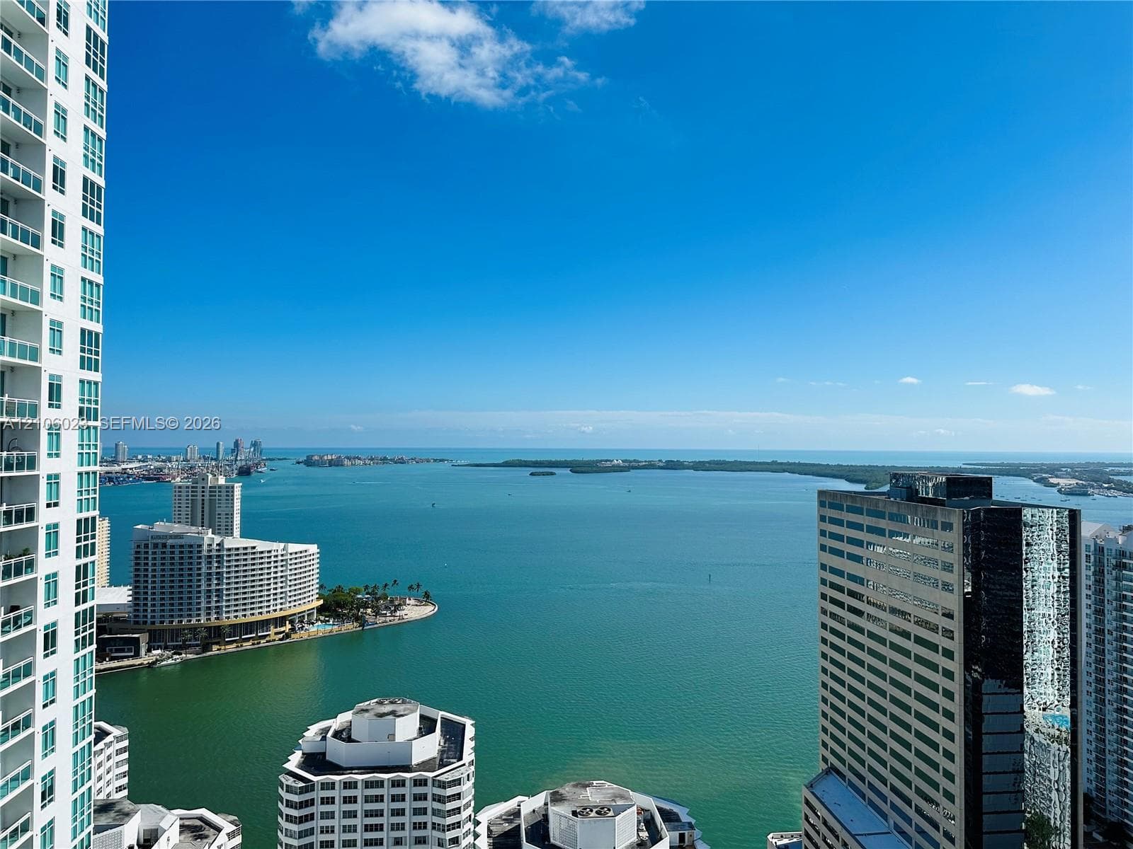 Expansive waterfront vista overlooking Biscayne Bay with turquoise waters and distant skyline
