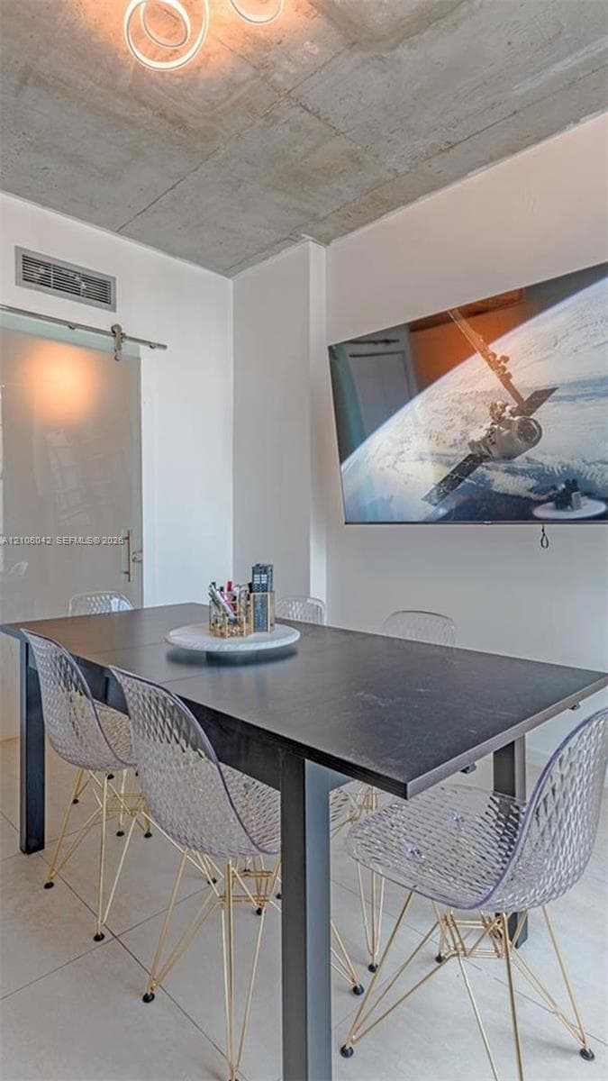 Exposed concrete ceiling, large-format tile flooring, and frosted glass sliding door with stainless steel hardware