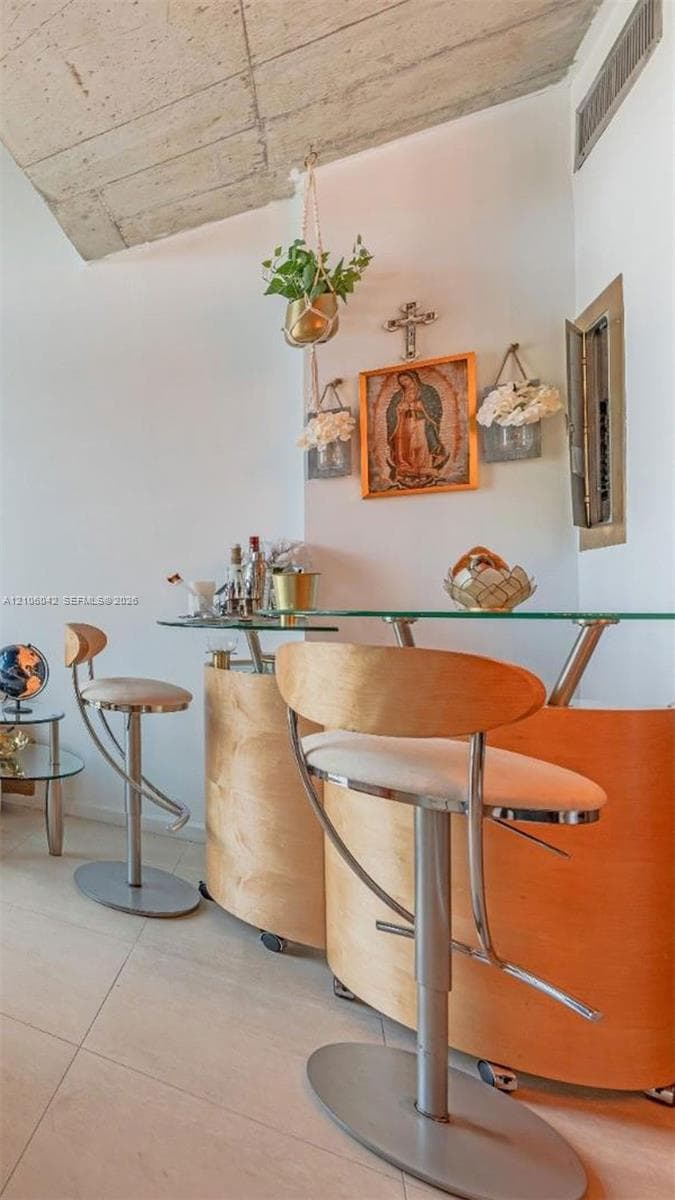 Exposed concrete ceiling and large-format tile flooring