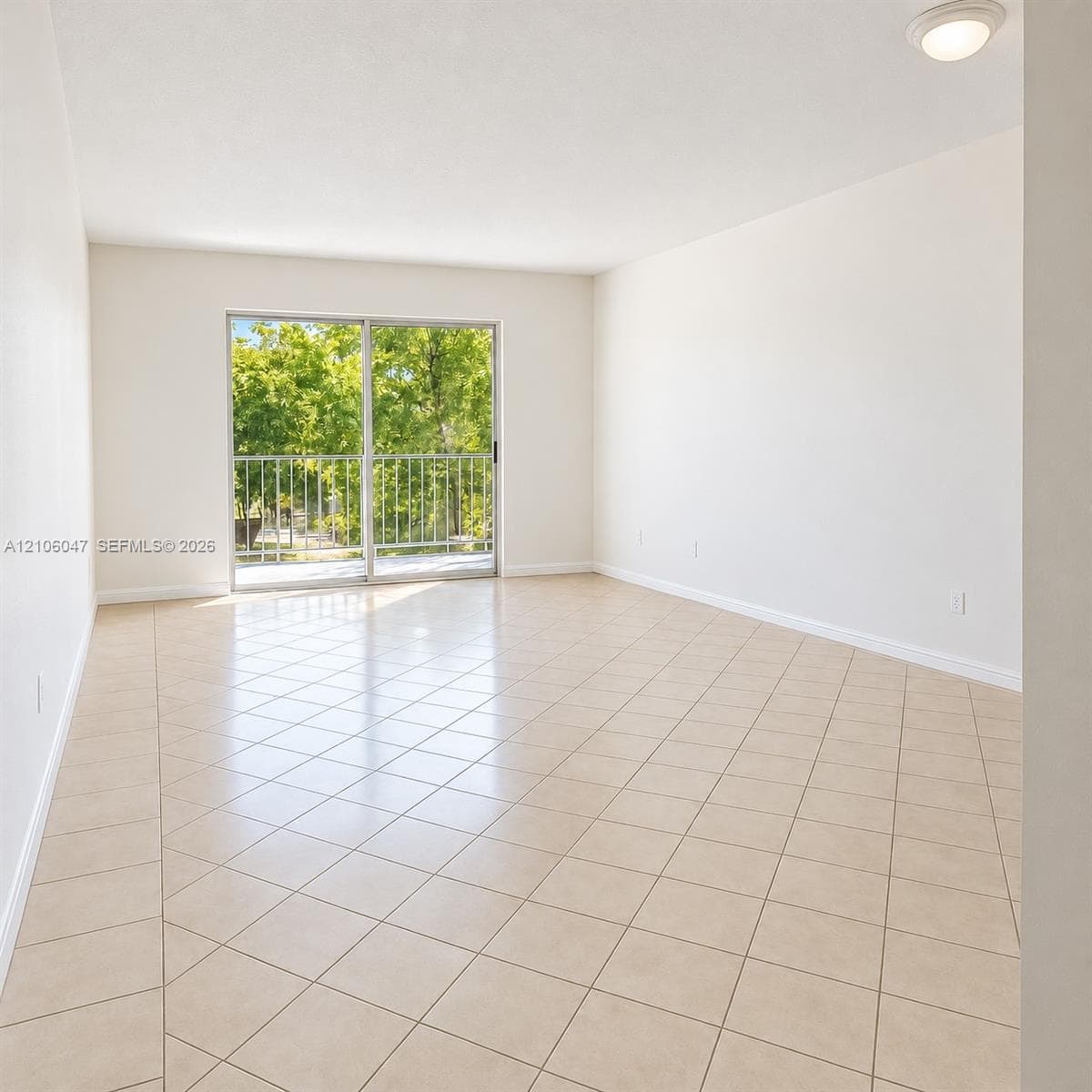 Neutral-toned tile flooring, sliding glass door, and metal balcony railing