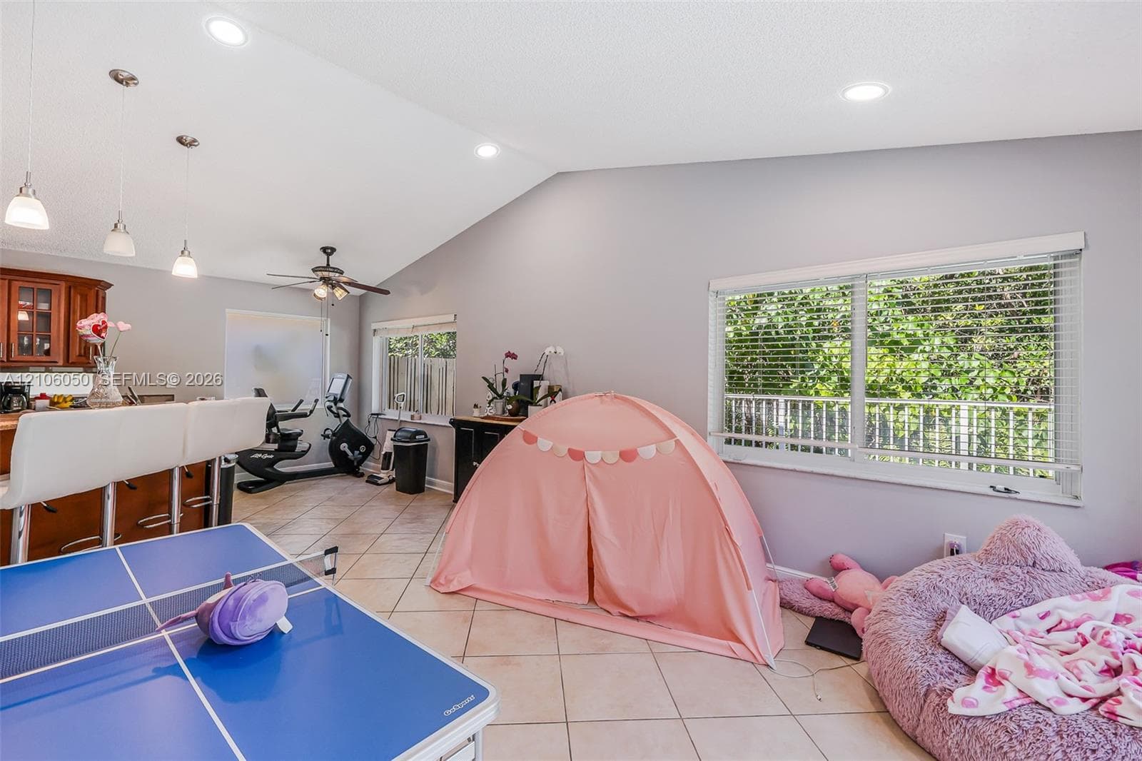 Vaulted ceilings, tile flooring, recessed lighting, pendant lighting, and horizontal window blinds