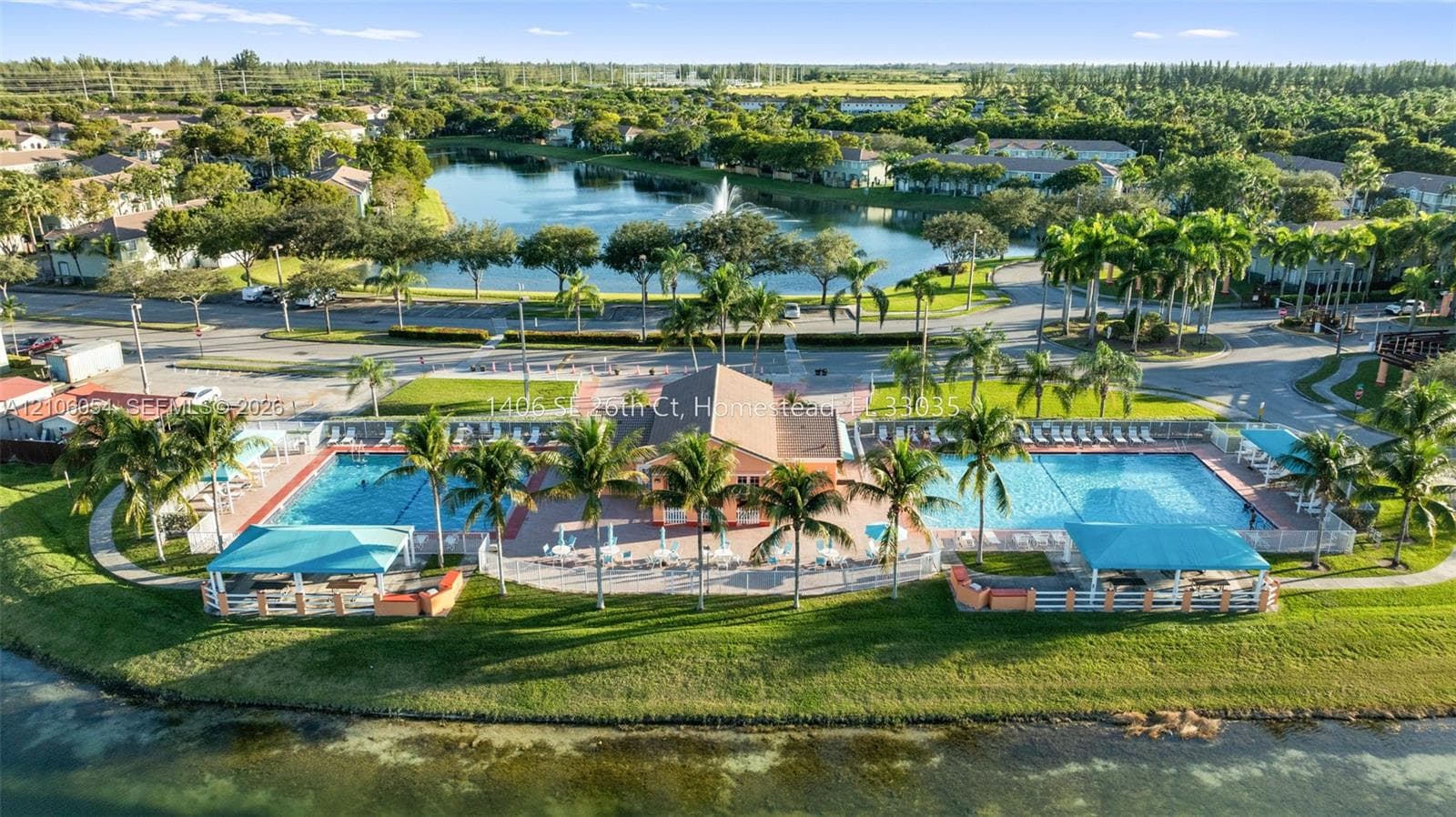 Community amenities featuring two swimming pools, covered outdoor pavilions, a clubhouse, and a waterfront setting