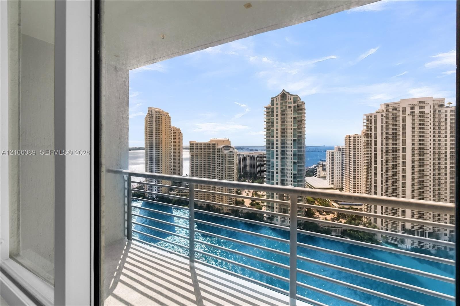 Covered balcony featuring a metal railing and tile flooring