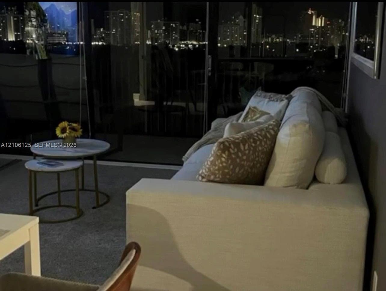 Floor-to-ceiling sliding glass panels with exterior lighting