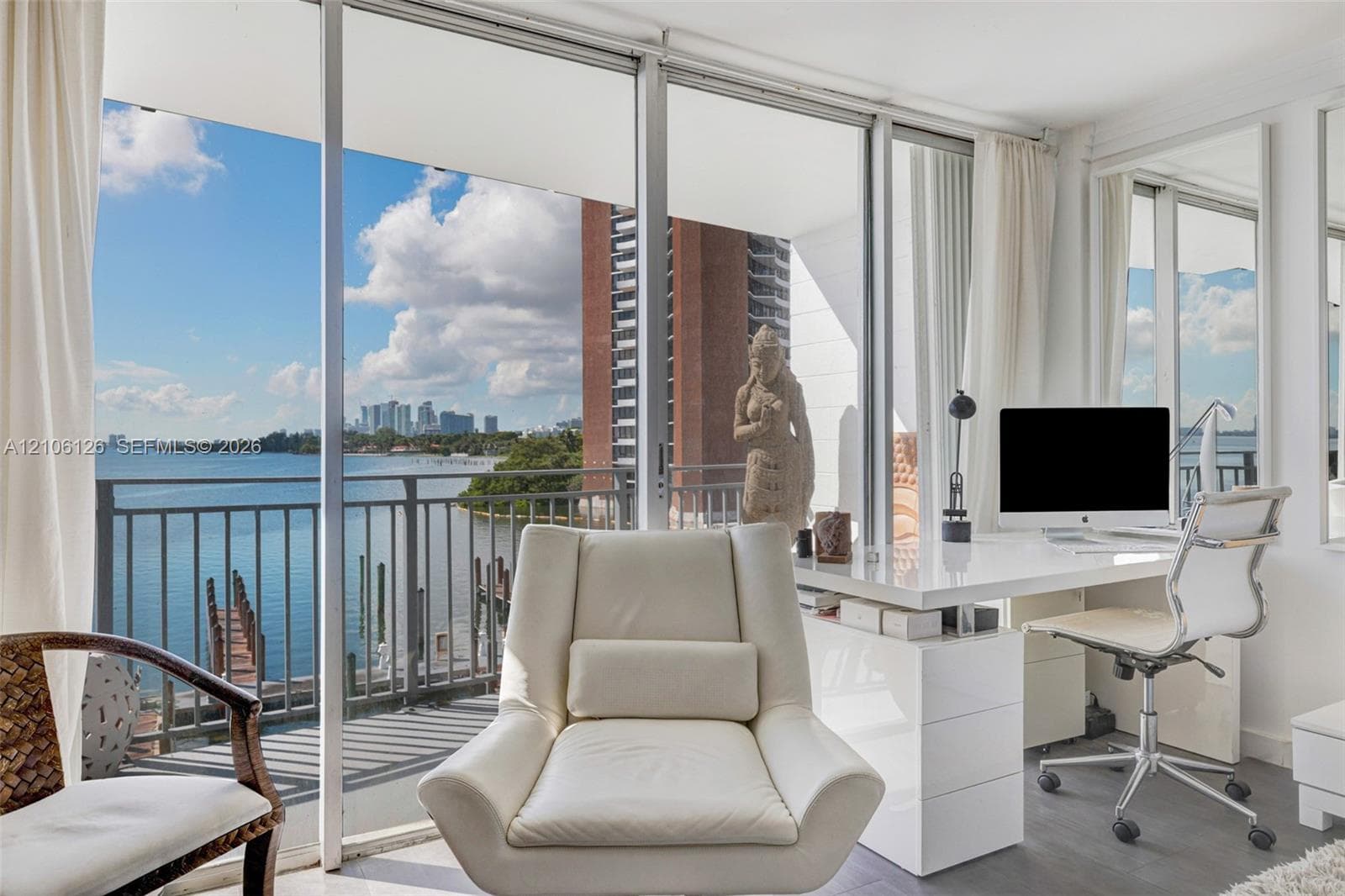 Floor-to-ceiling sliding glass panels, wood-finish flooring, and built-in shelving