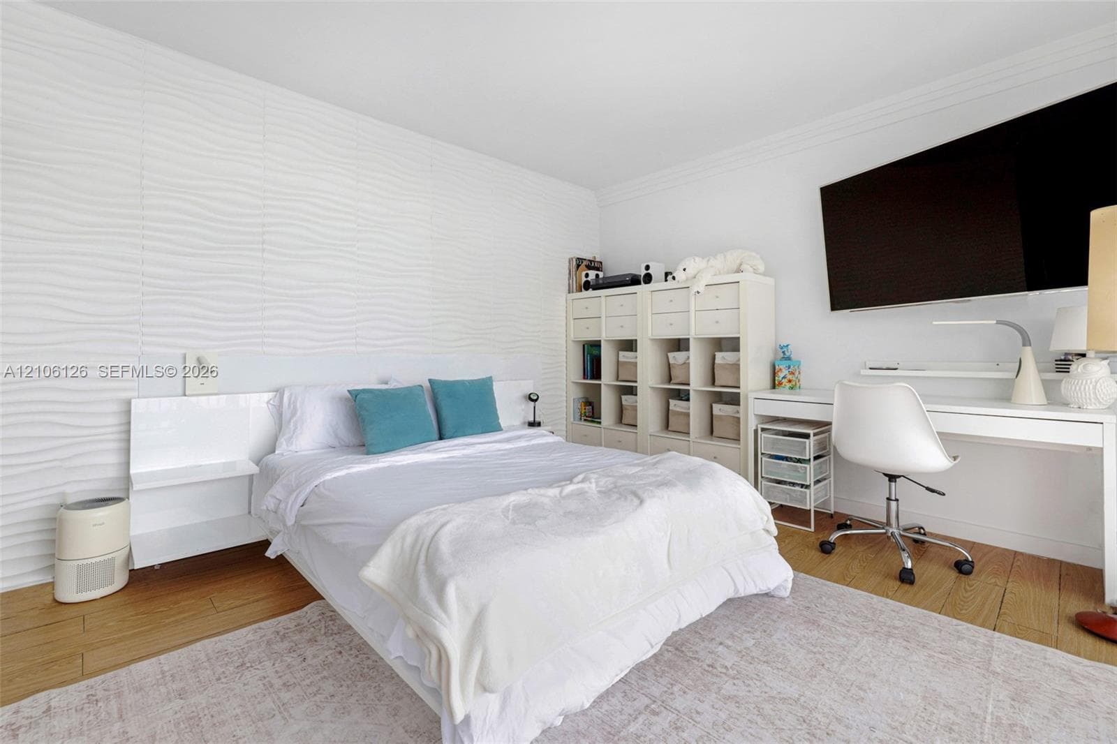 Floor-to-ceiling glass sliding doors opening to an expansive balcony with metal railing, carpeting, and water scenery