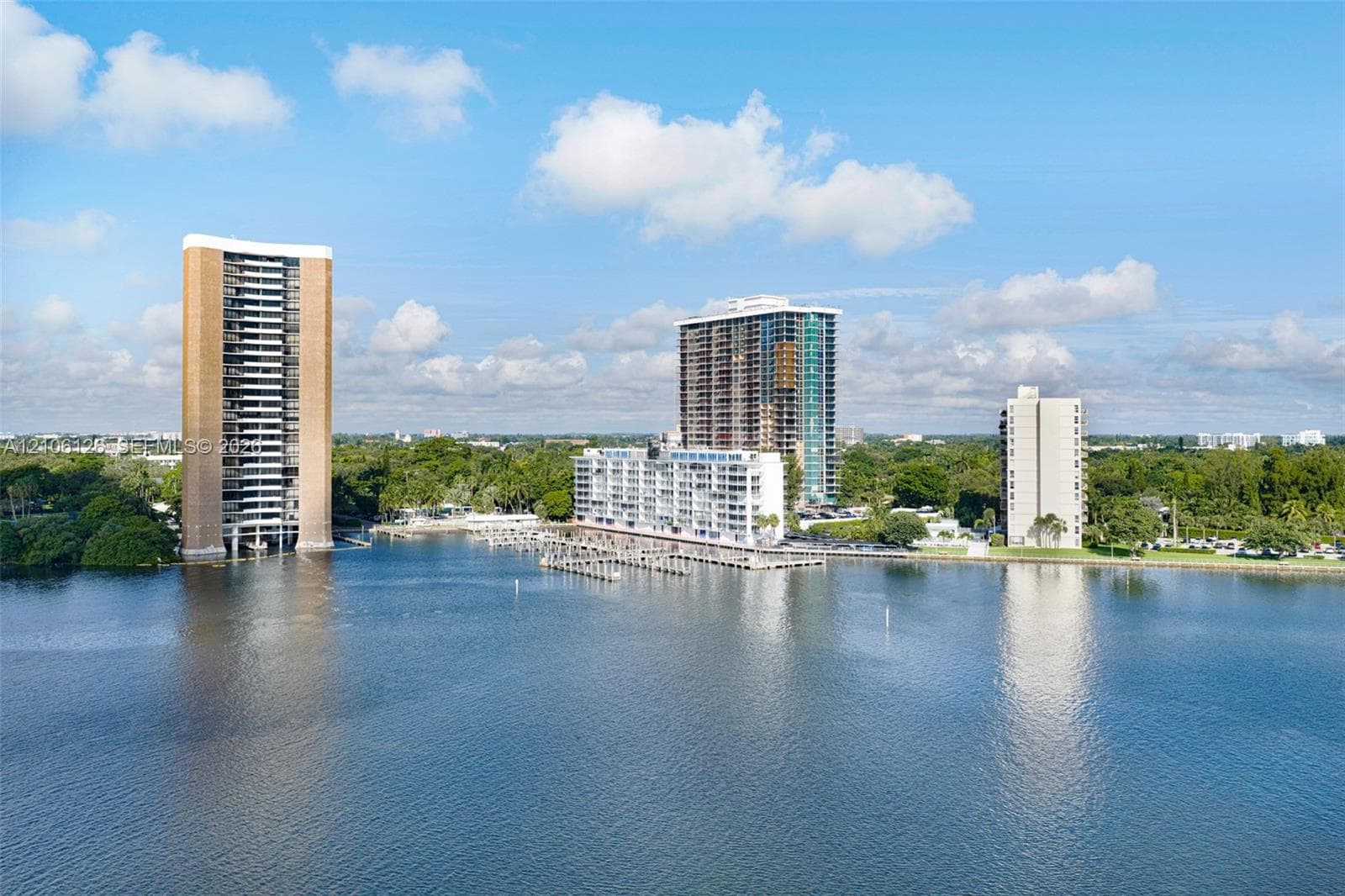 Waterfront high-rise complex featuring deep-water boat slips, private dockage, and extensive shoreline perimeter