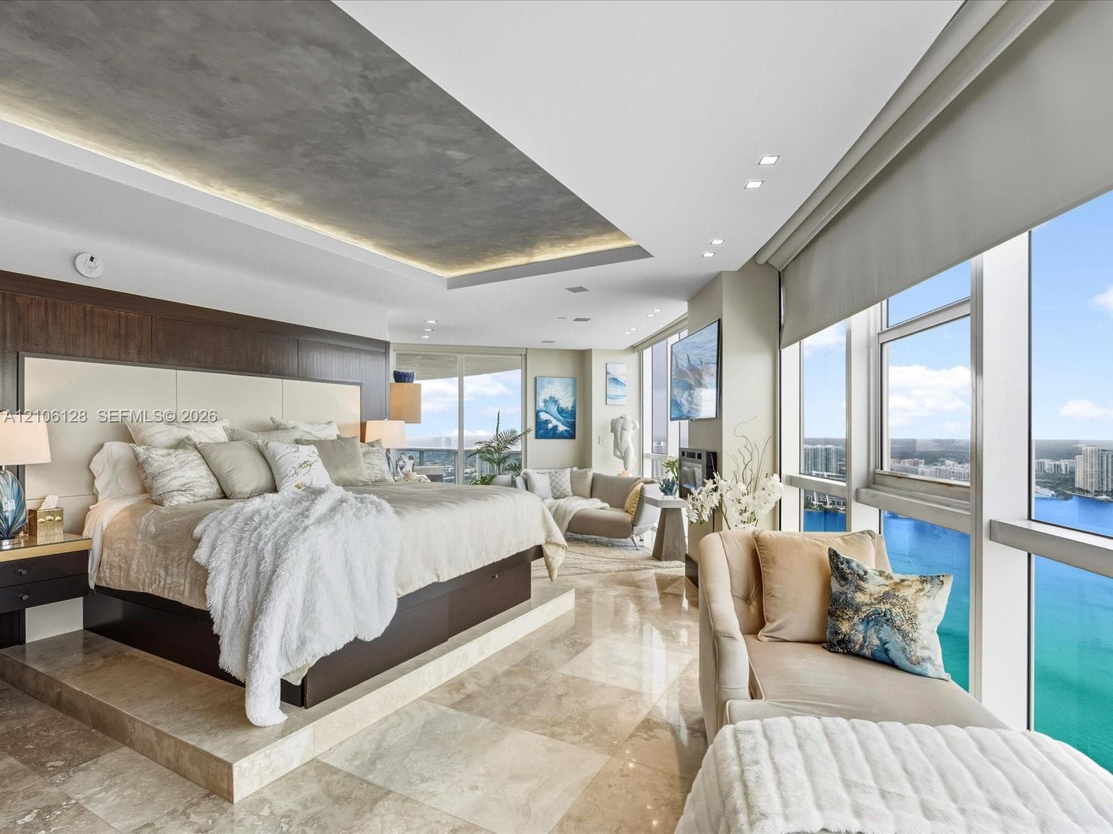 Floor-to-ceiling windows, polished stone flooring, recessed ceiling feature with ambient lighting, and dark wood-finish wall paneling