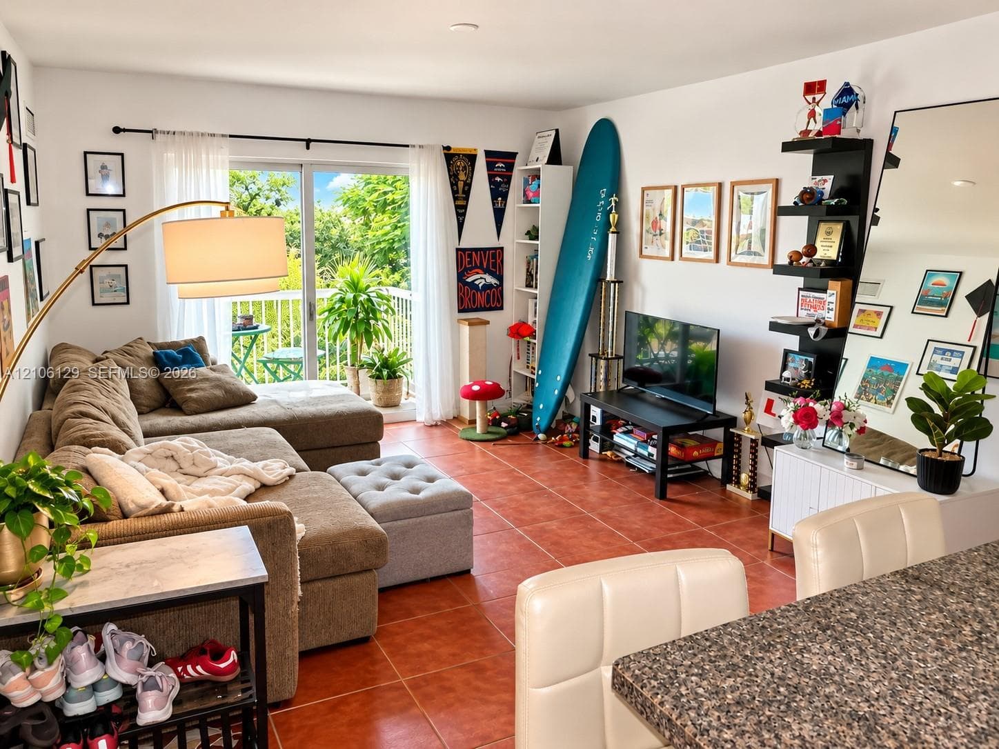 Ceramic tile flooring, sliding glass patio door, and balcony with metal railing
