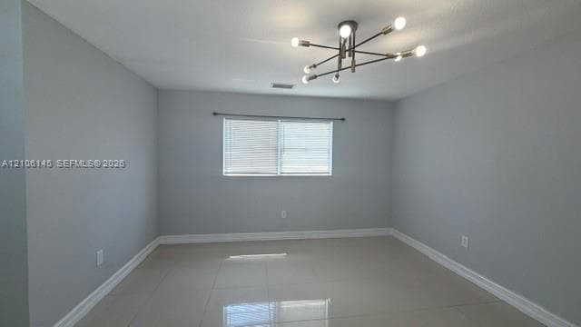 Neutral wall tones, polished tile flooring, and a multi-arm sputnik-style chandelier