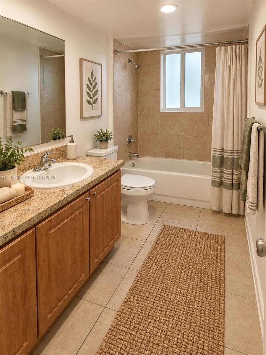 Bathroom featuring a wood-finish vanity with a stone-composite countertop, integrated sink, tile flooring, and a tiled shower-tub surround