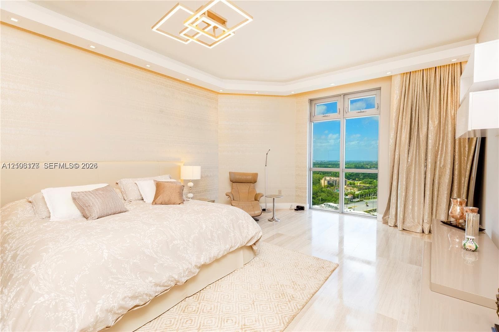 Floor-to-ceiling windows, recessed tray ceiling with accent lighting, contemporary geometric pendant lighting, polished stone-finish flooring, and textured wall finish