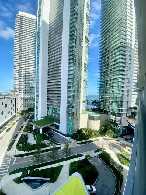High-rise residential towers featuring glass-curtain facades, expansive balconies, landscaped grounds, and proximity to the waterfront