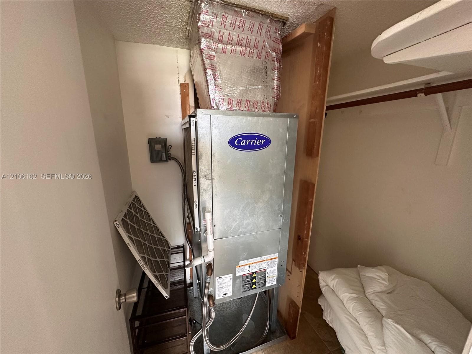 Carrier HVAC unit featuring a metal air handler, insulated ductwork, and integrated filtration system