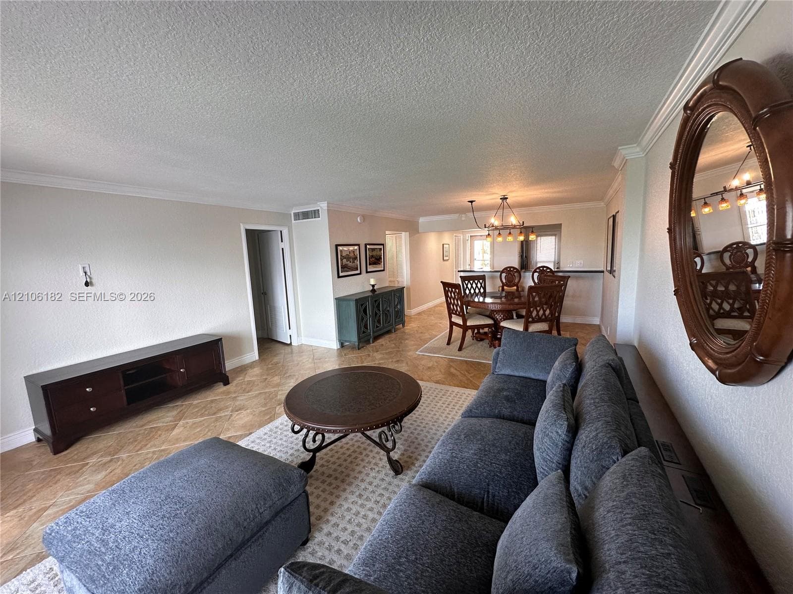 Diagonal tile flooring, crown molding, and neutral interior paint palette