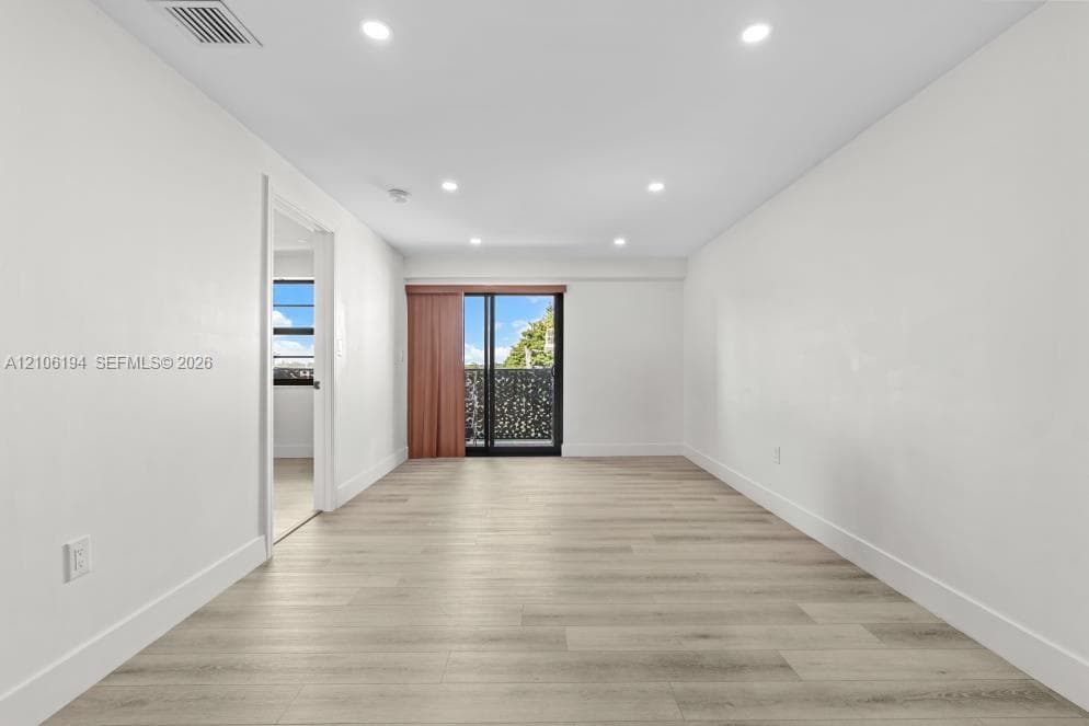 Living room featuring recessed lighting, and   a sliding glass door a decorative metal balcony screen