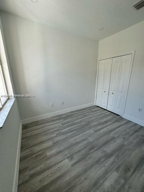 Interior space featuring neutral wall paint, wood-finish flooring, recessed lighting, and a double-door closet