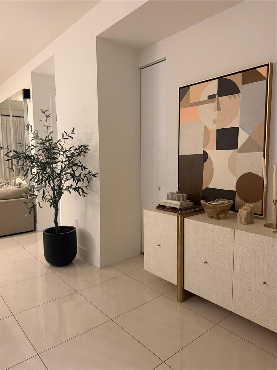 Large-format light-toned tile flooring and neutral wall finishes