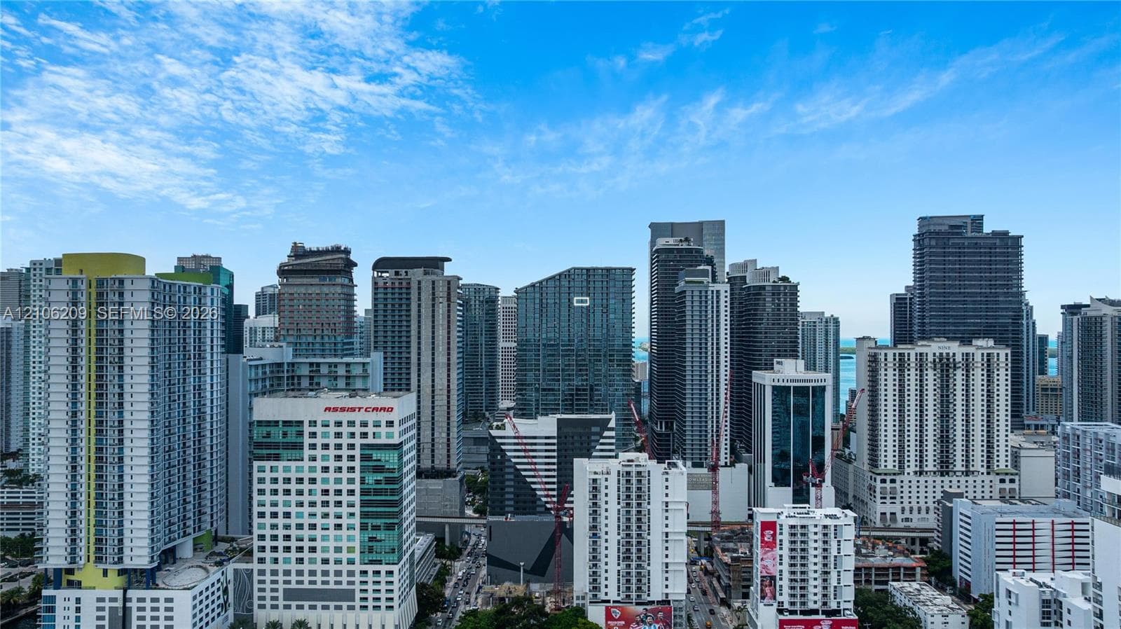 Panoramic skyline perspective featuring high-rise urban architecture and clear blue skies