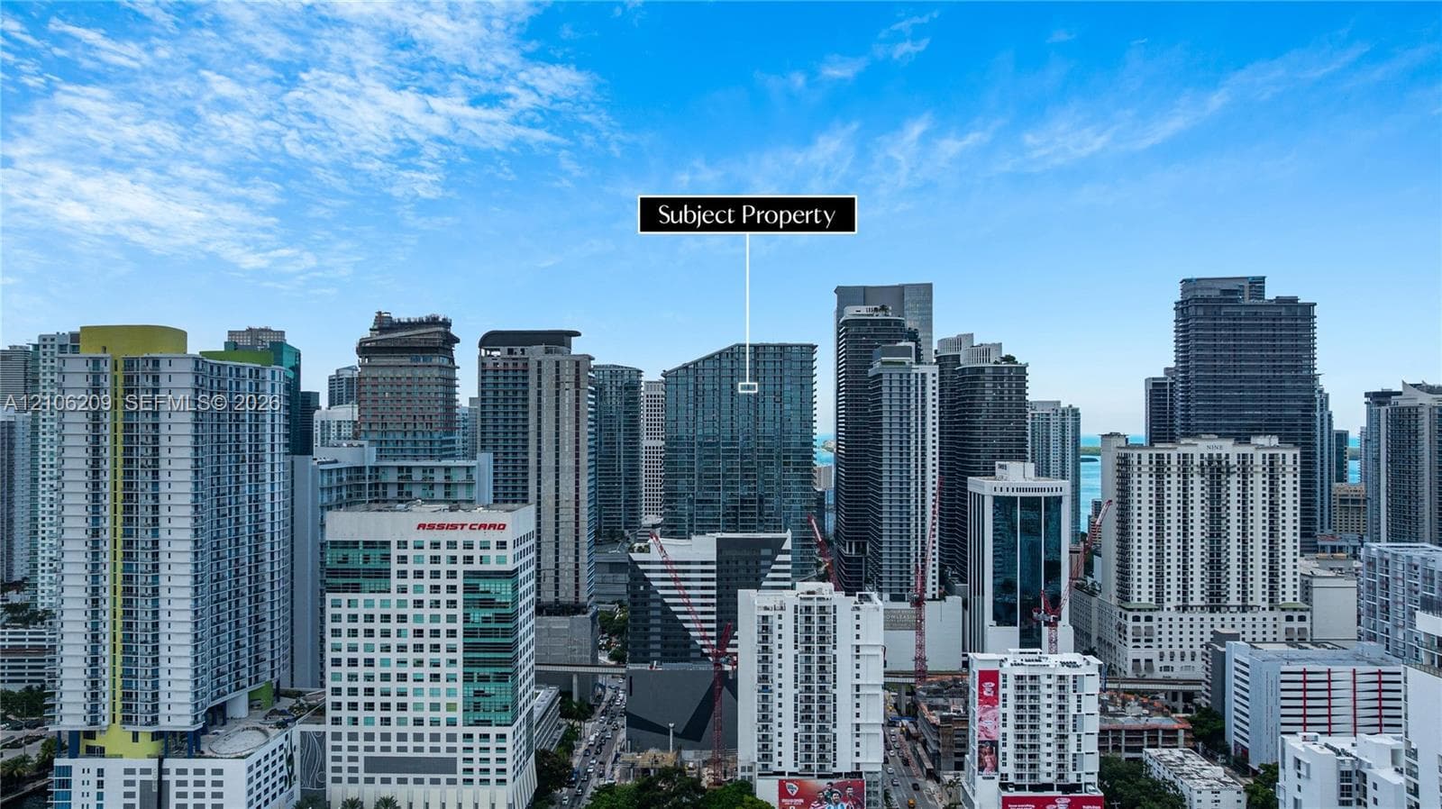 High-rise building featuring a glass facade and modern architectural design situated within an urban metropolitan landscape