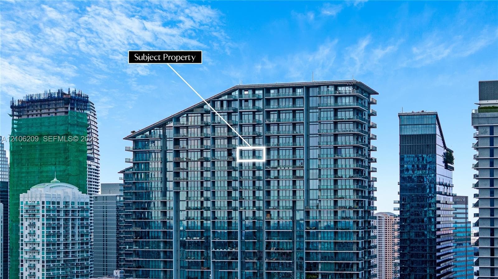 High-rise architectural exterior featuring a glass curtain wall, angular roofline, and private recessed balconies