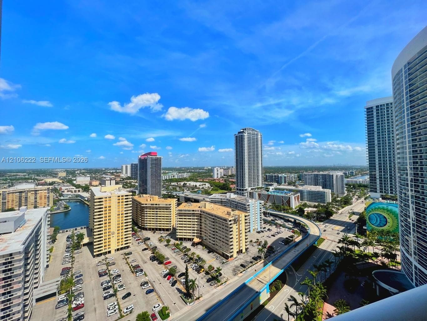 High-rise panoramic perspective featuring an urban cityscape, surrounding waterways, and expansive skyline exposure