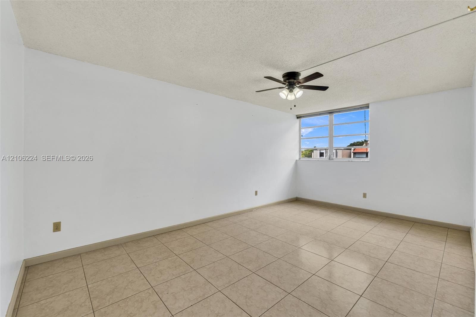 Interior space featuring tile flooring, a multi-pane window, and a ceiling fan with integrated lighting