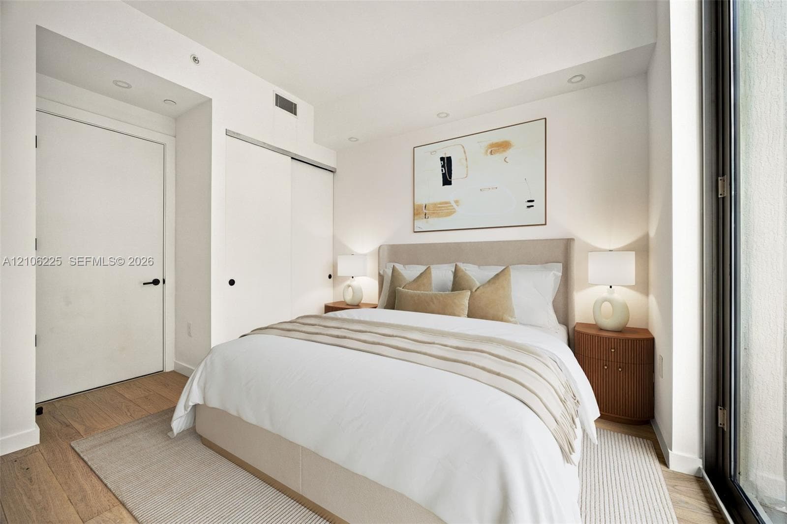 Room featuring wood-finish flooring, recessed lighting, and a sliding-door closet