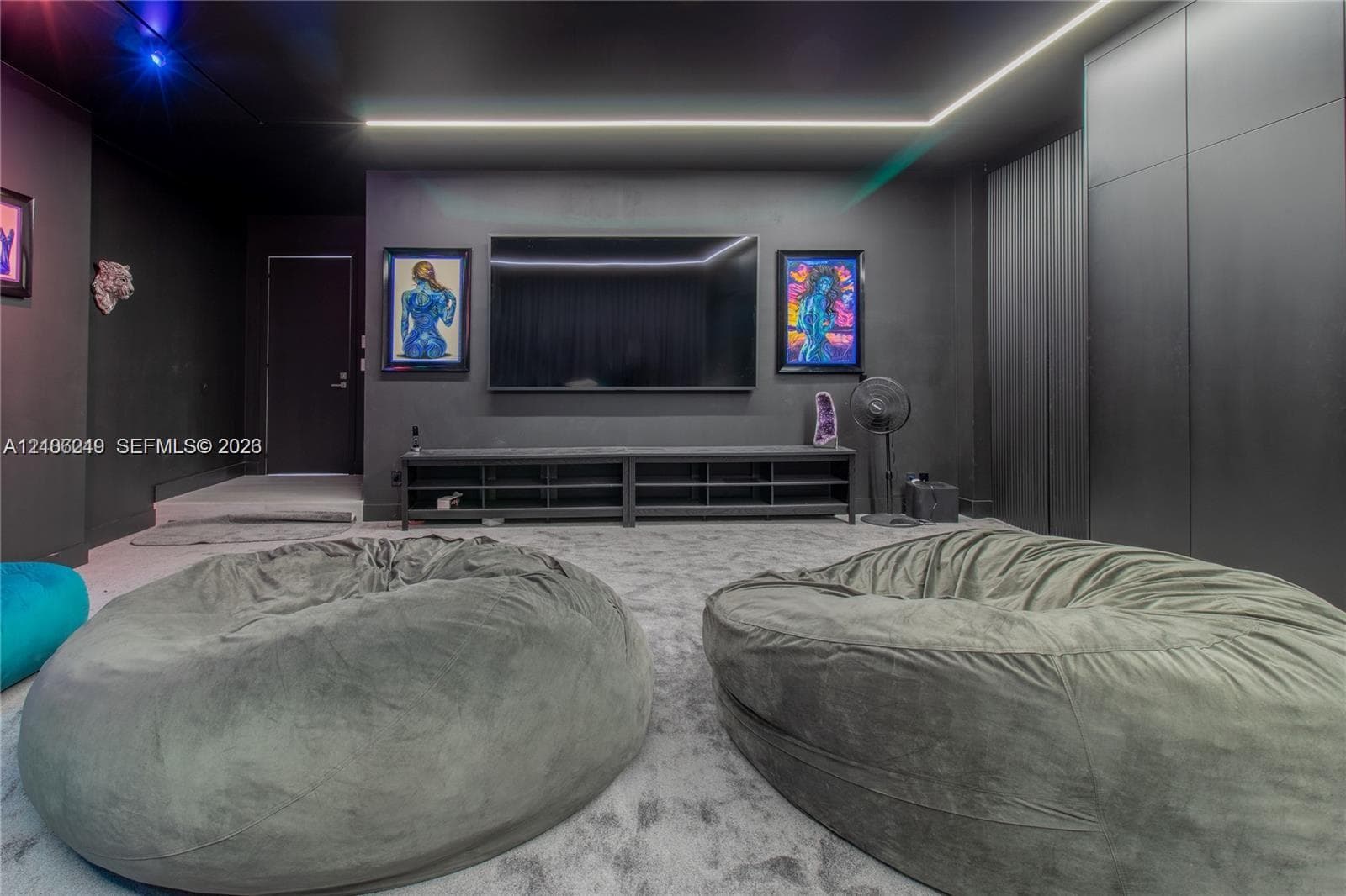 Monochromatic interior featuring floor-to-ceiling cabinetry, recessed linear perimeter lighting, and high-contrast walls