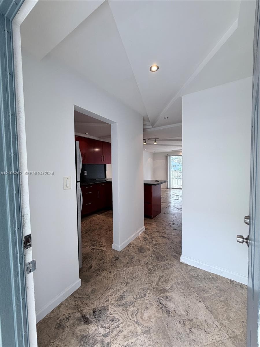 Entryway featuring stone-tile flooring, recessed ceiling lighting, and a neutral color palette