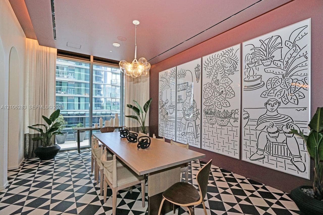 Geometric patterned tile flooring, floor-to-ceiling glass windows, recessed ceiling lighting, and a multi-globe pendant light fixture
