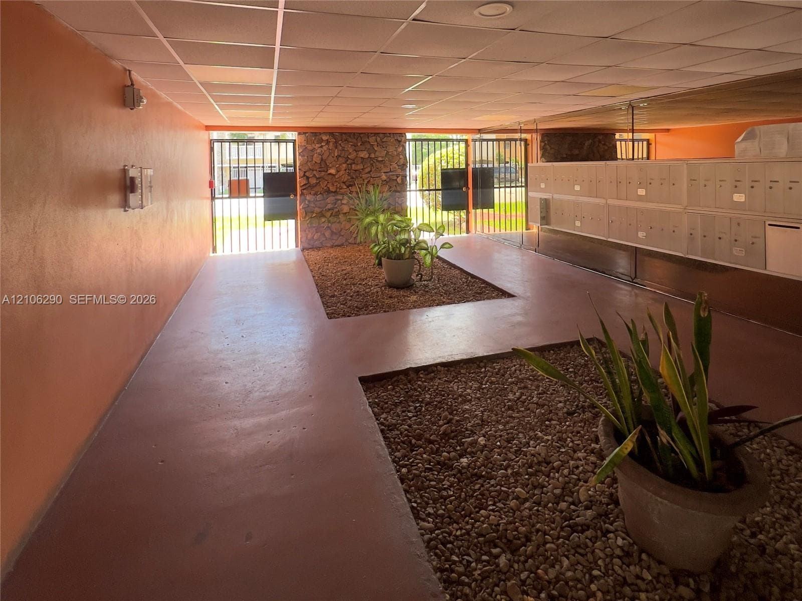 Covered entryway mailroom with secured gates