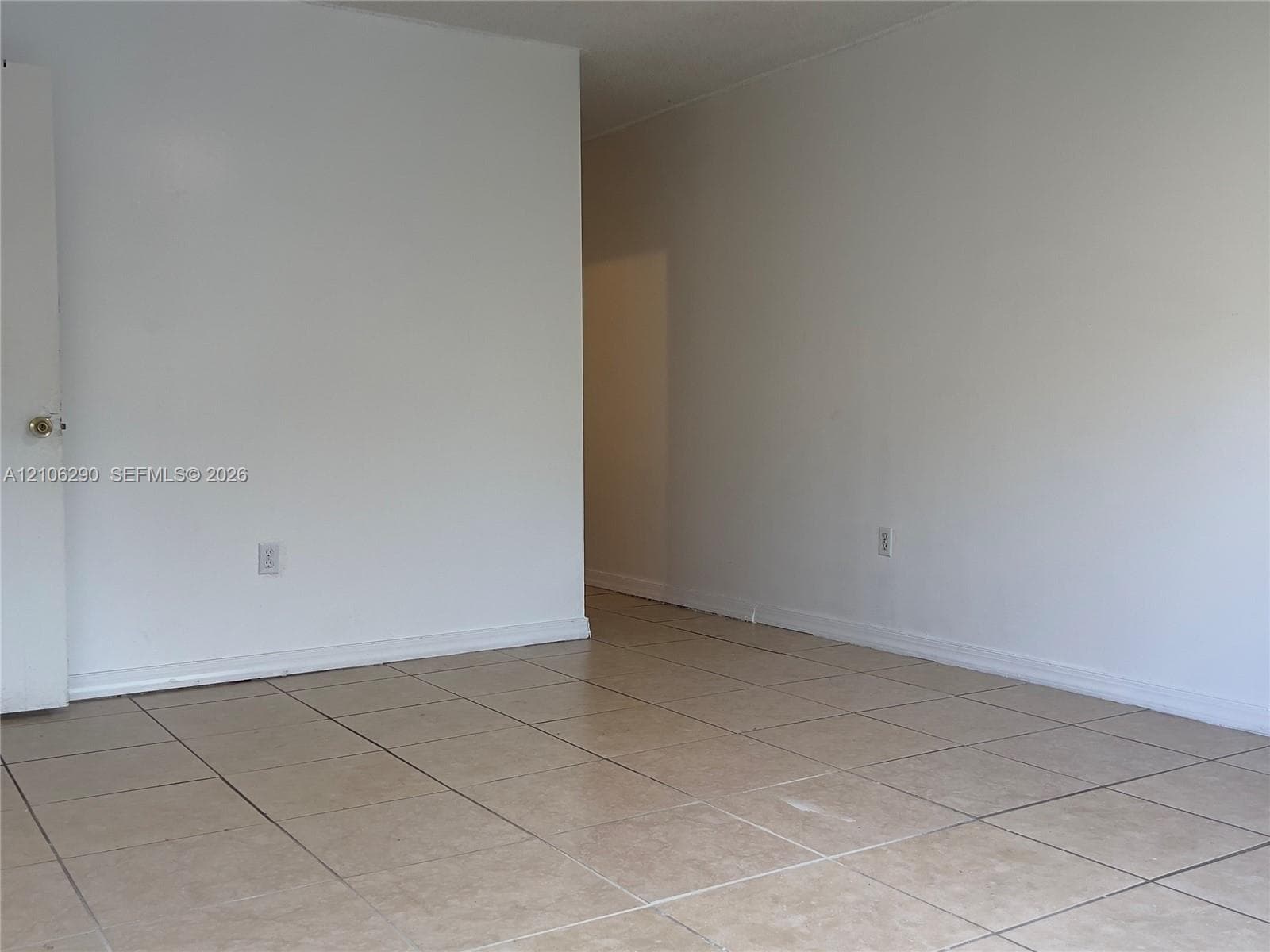 Neutral interior featuring square tile flooring and white walls