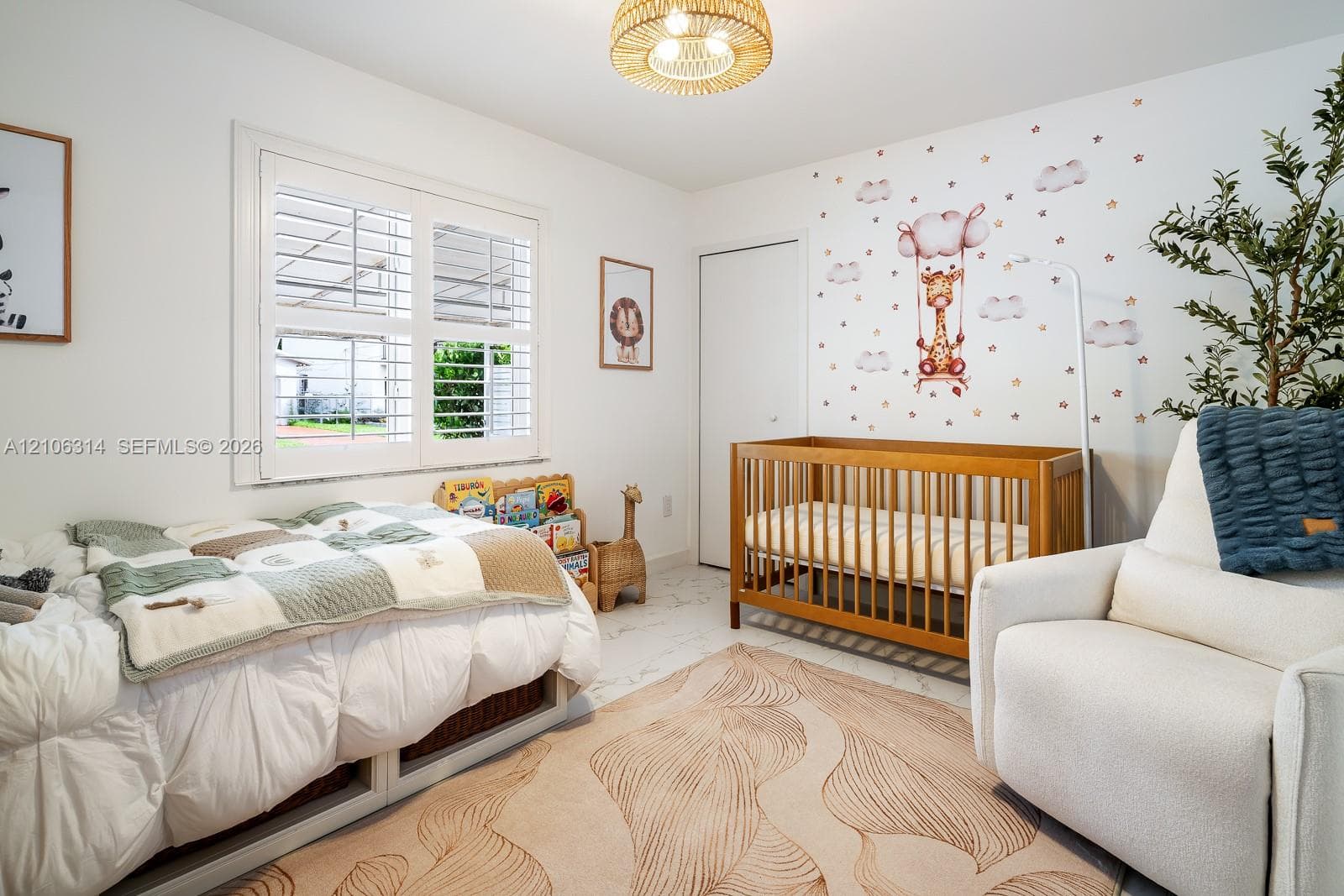 Interior room featuring large-format tile flooring, white plantation shutters, and a textured drum pendant light fixture