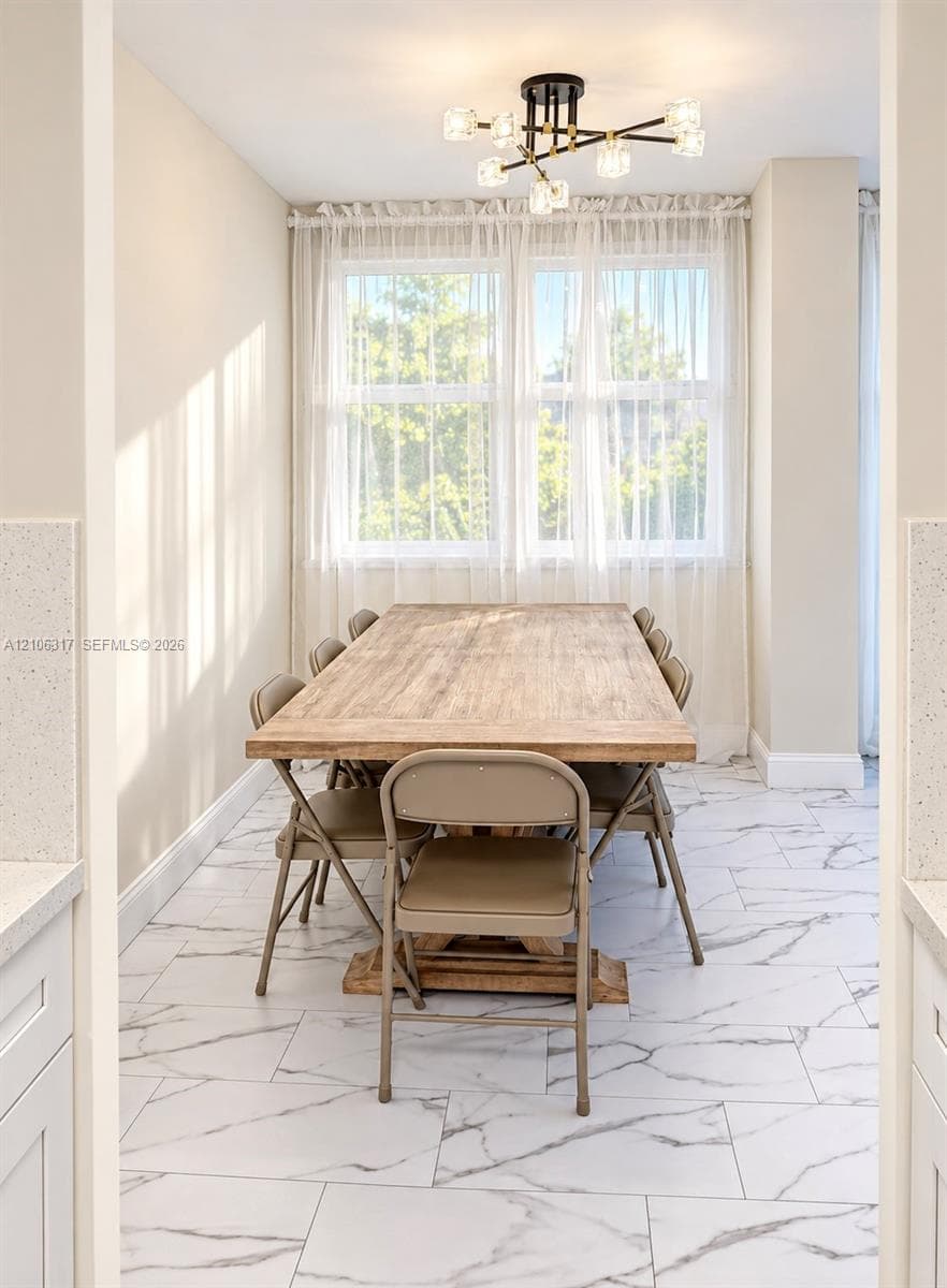 Large format light-toned stone-patterned tile flooring, multi-light geometric chandelier, and dual-pane windows