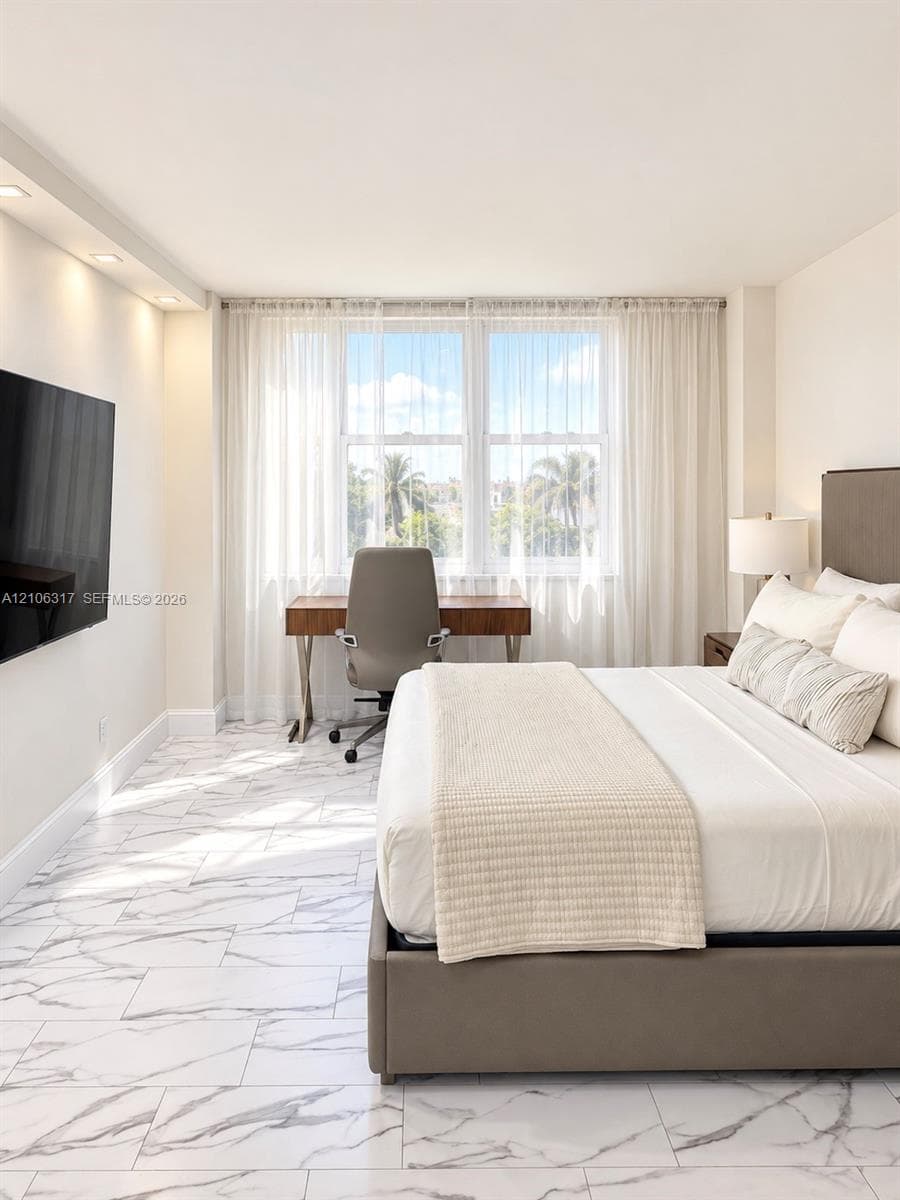 Large-format stone-style tile flooring, recessed ceiling lighting, and expansive windows