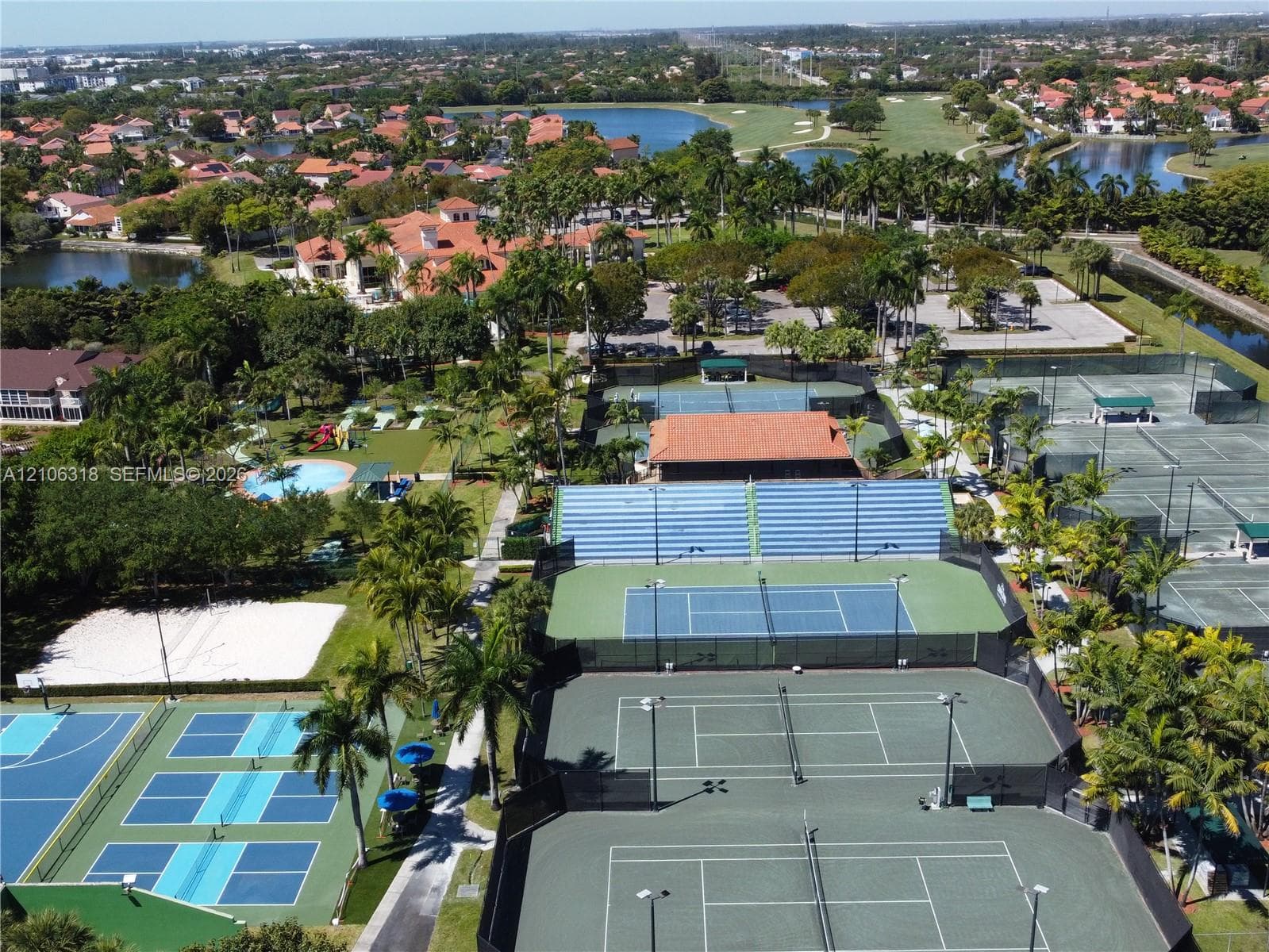 Doral Country Club is a recreational complex featuring multiple tennis courts, pickleball courts, a swimming pool, and landscaped surroundings